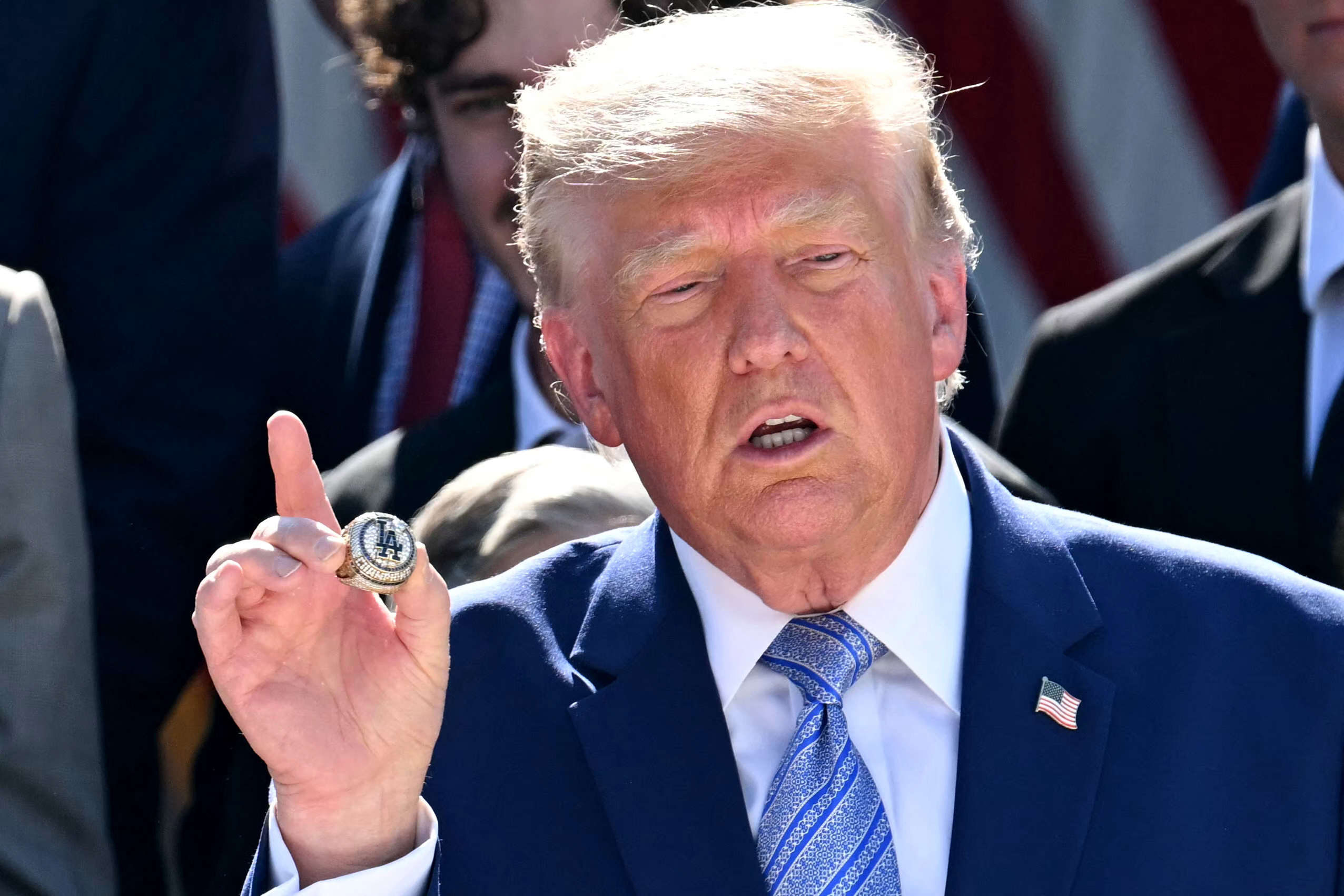US President Donald Trump shows an LA Dodgers Championship Ring during a ceremony to honor the 2025 World Series champions Los Angeles Dodgers in the Rose Garden at the White House in Washington, DC, on July 23, 2026.