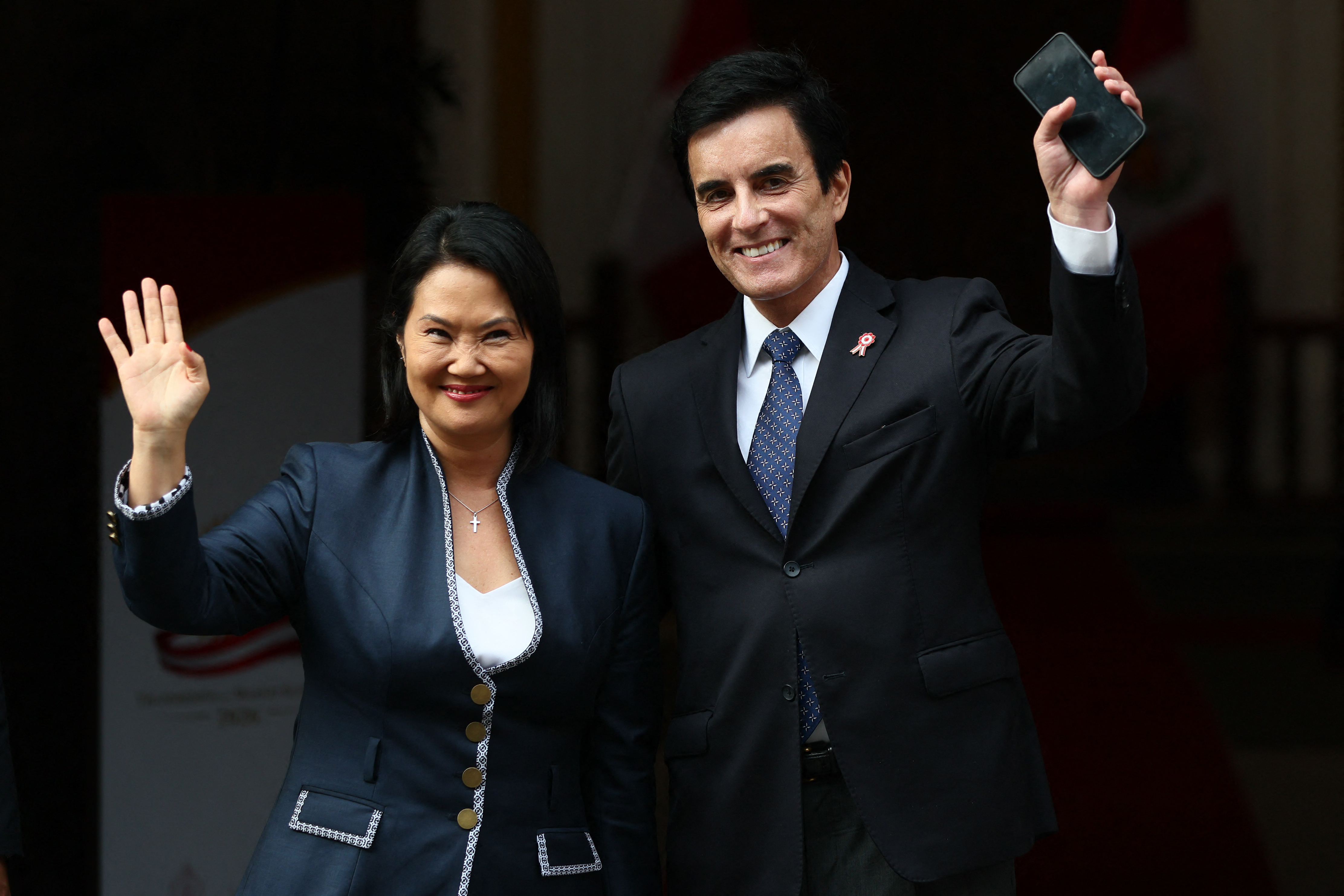 Peru's President-elect Keiko Fujimori (L) and appointed Foreign Minister Carlo Espa wave as they wait for foreign delegations arriving at the Foreign Ministry for bilateral meetings ahead of Fujimori's inauguration in Lima on July 27, 2026. (Photo by Connie FRANCE / AFP)
