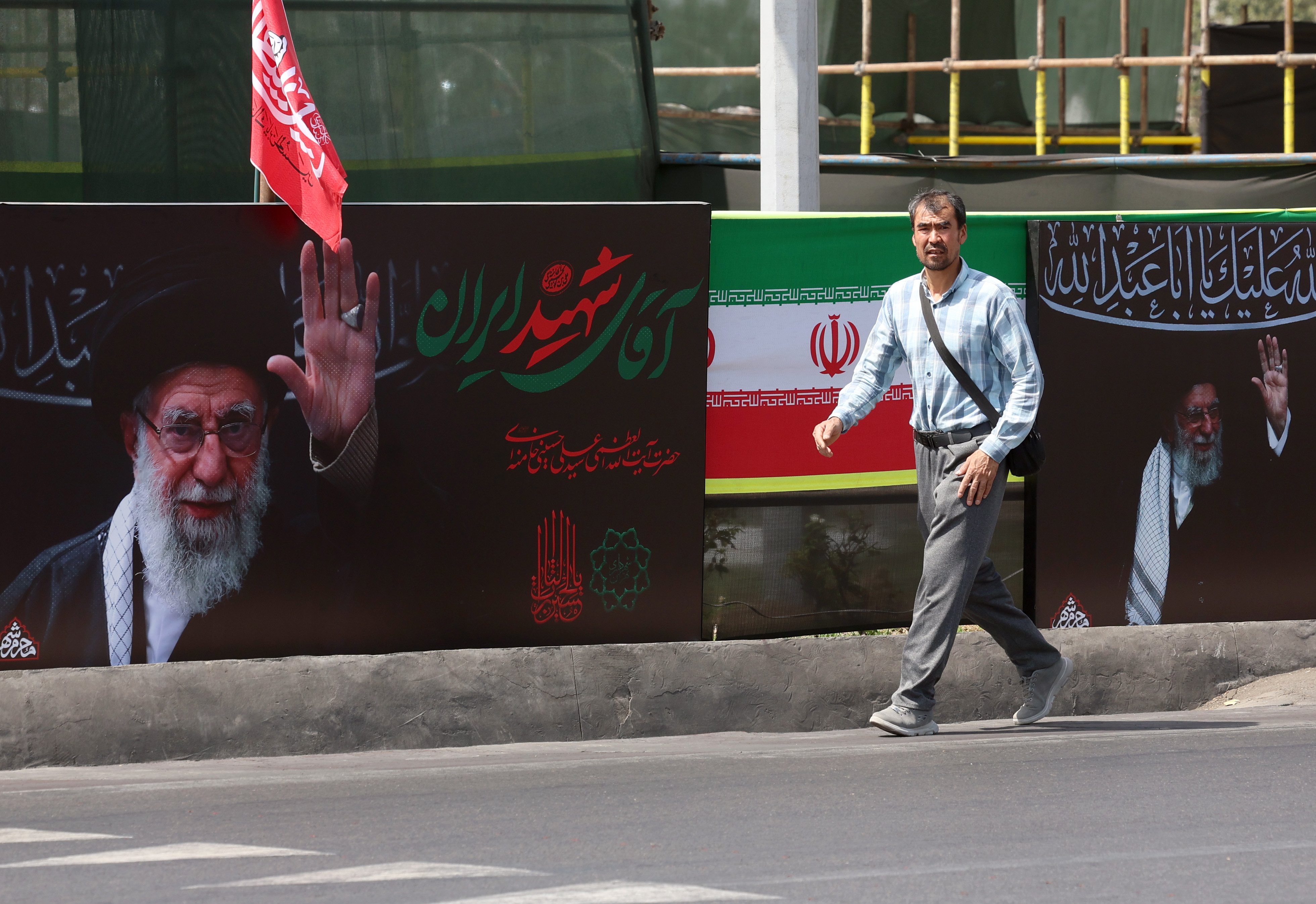 epa13129789 An Iranian man walks next to the pictures of late Iranian supreme leader Ayatollah Ali Khamenei on a street in Tehran, Iran, 24 July 2026. Conflict between Iran and the US over the Strait of Hormuz continues, as US strikes have targeted several locations across Iran. EPA/ABEDIN TAHERKENAREH RESTRICTIONS: NO Access Israel Media/Persian Language TV Stations Outside Iran/Strictly No Access BBC Persian/VOA Persian/Manoto TV/Iran International TV. (As mandated by Iran's Directorate General for Foreign Media) --