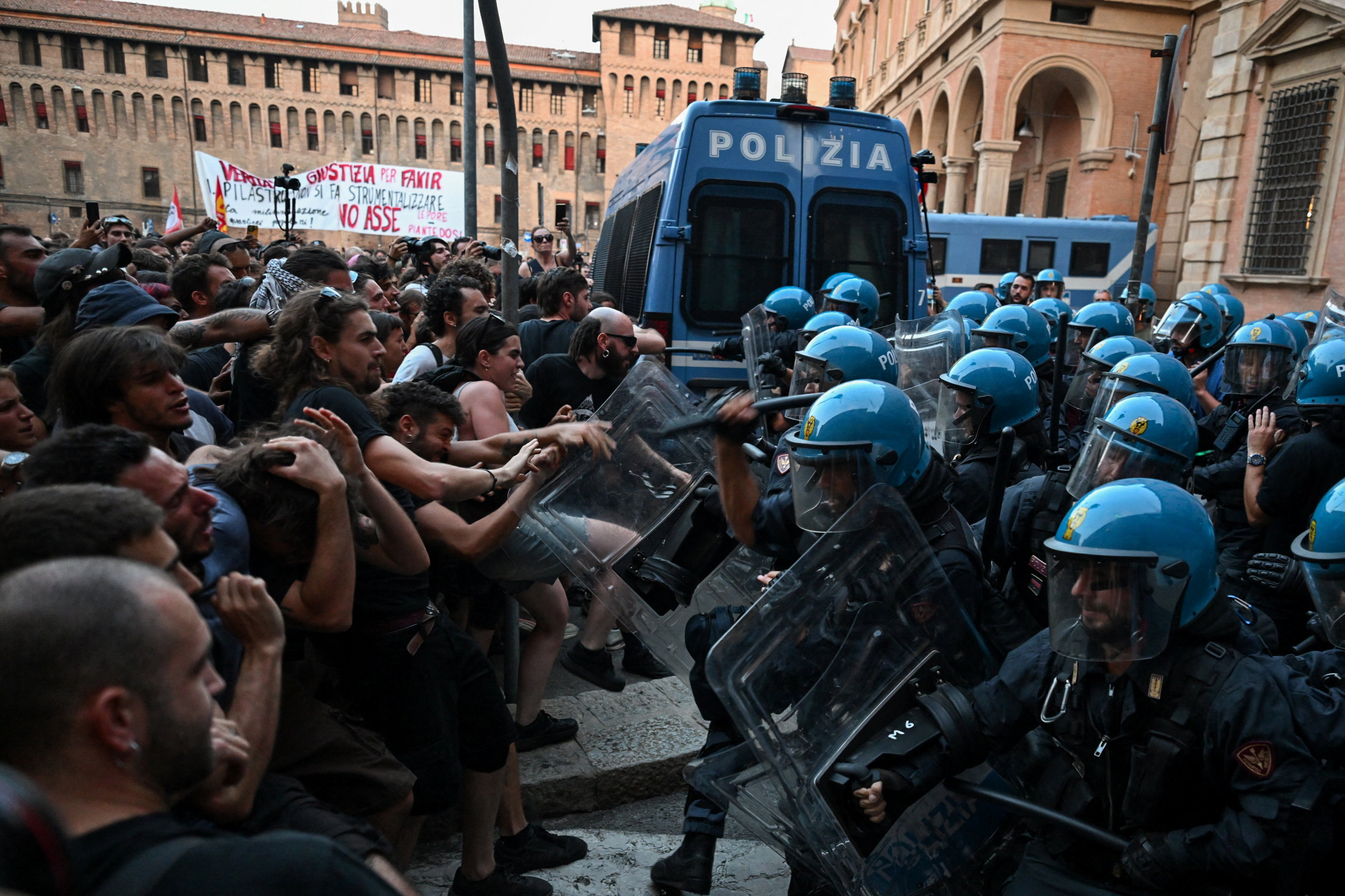 Protesters clash with riot police during a protest following the death of Abderrahim Fakir after he was restrained by police during an attempted detention, in Bologna, Italy, July 20, 2026. REUTERS/Michele Lapini