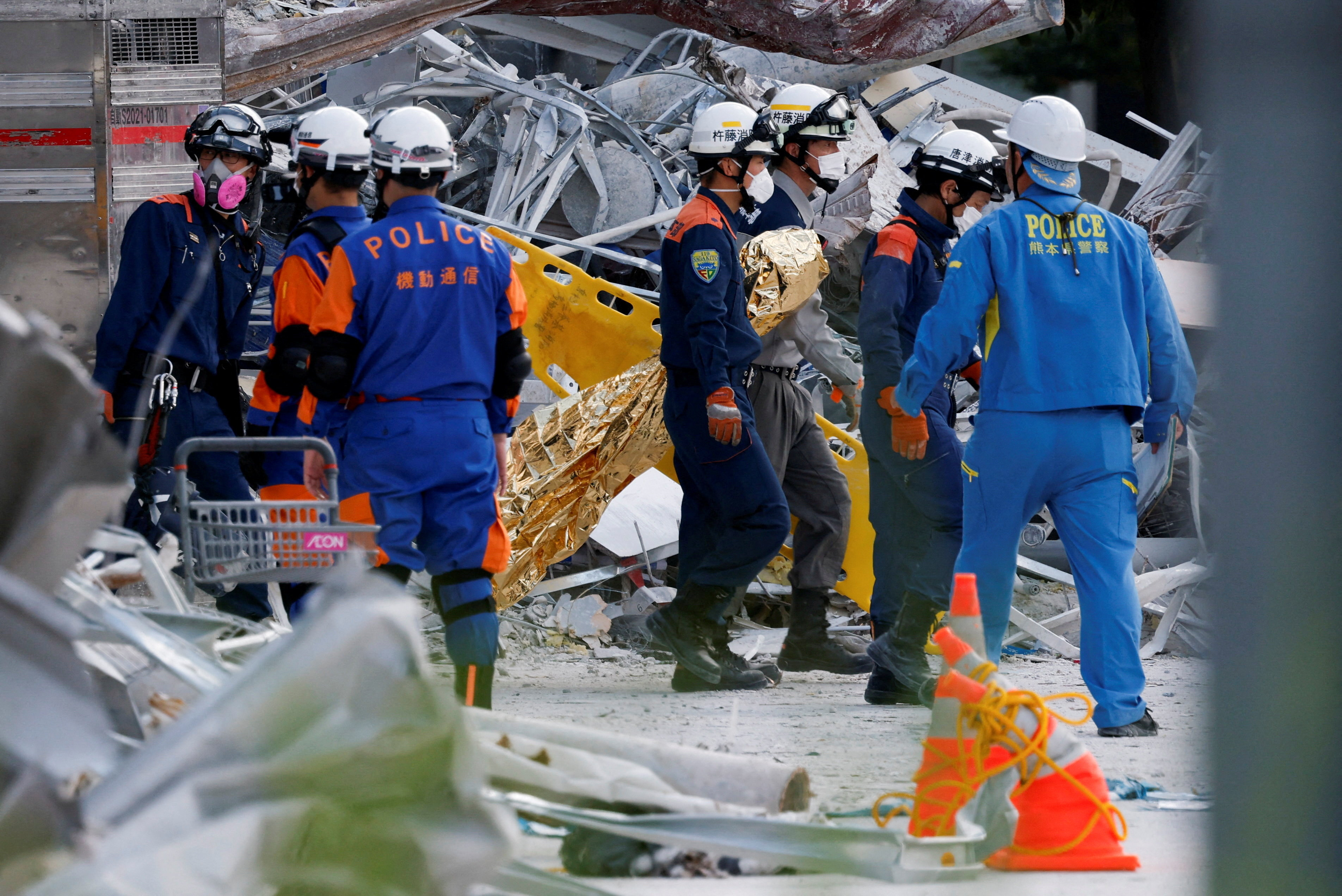 Rescue workers conduct a search operation at the damaged Aeon Mall shopping centre after an earthquake with a magnitude of 7.1 struck Japan's southern Kumamoto Prefecture, in Kashima Town, Kumamoto Prefecture, Japan, July 30, 2026. REUTERS/Kim Kyung-Hoon REFILE - QUALITY REPEAT