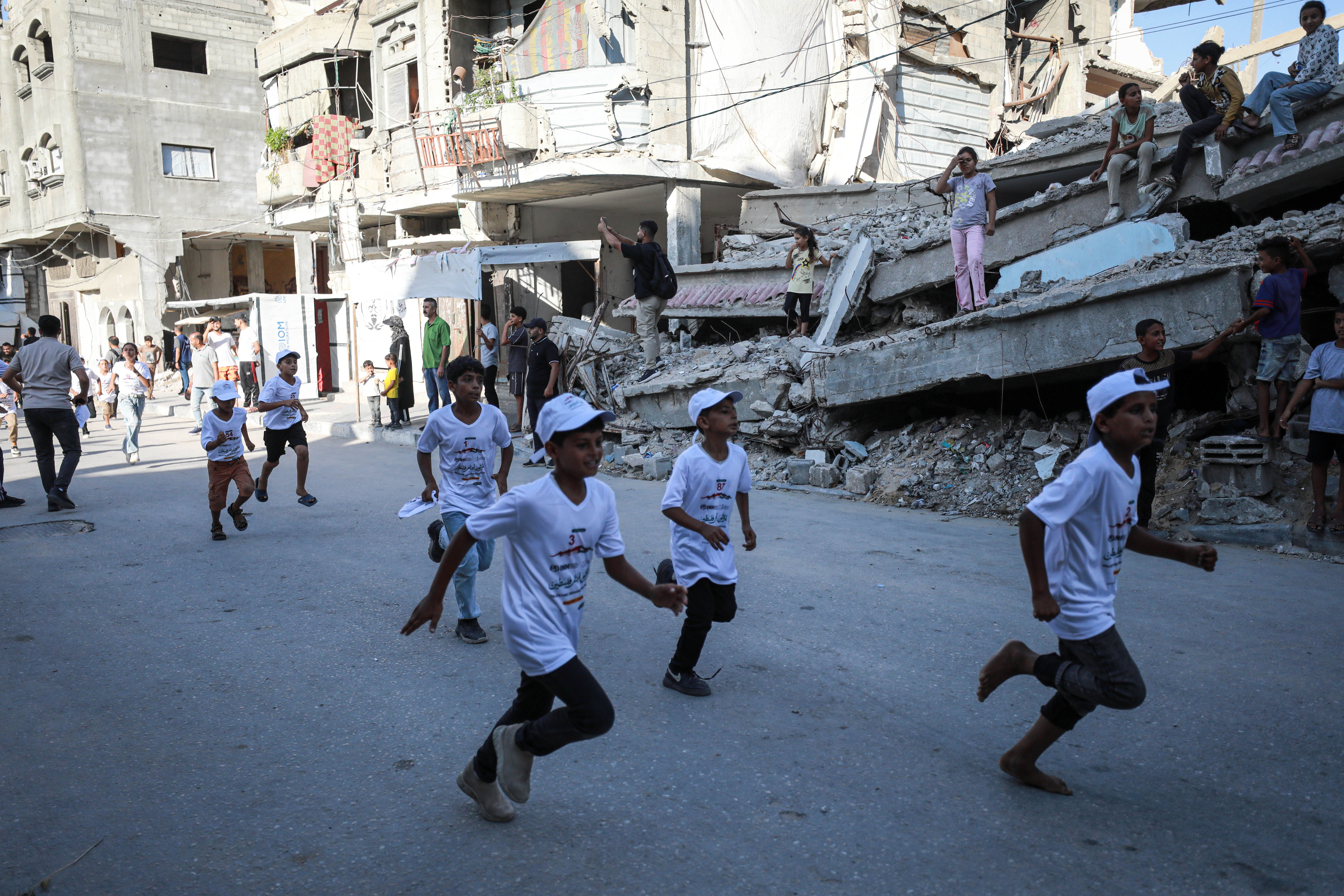 Children run in an orphan marathon organised in Gaza to raise awareness of the rights of orphaned children and the hardships they and their families face during the war [Abdelhakim Abu Riash/ Al Jazeera]