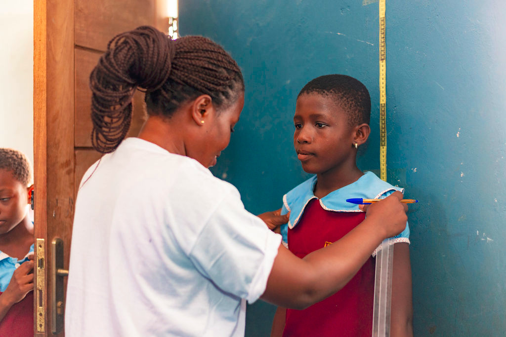 A child receives medical care as health workers provide services to communities in Ghana [Humserve Africa Foundation]