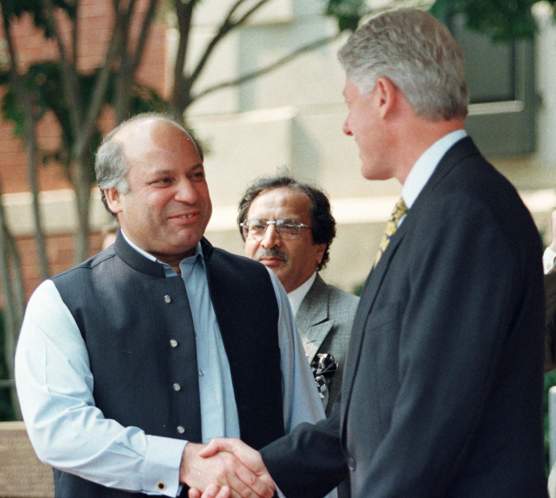 U.S. President Bill Clinton shakes hands with Pakistani Prime Minister Nawaz Sharif outside Blair House following their talks on Kashmir in Washington July 4. Clinton and Sharif said they had agreed that concrete steps will be taken to restore the line of control in Kashmir.TB/RC/kc