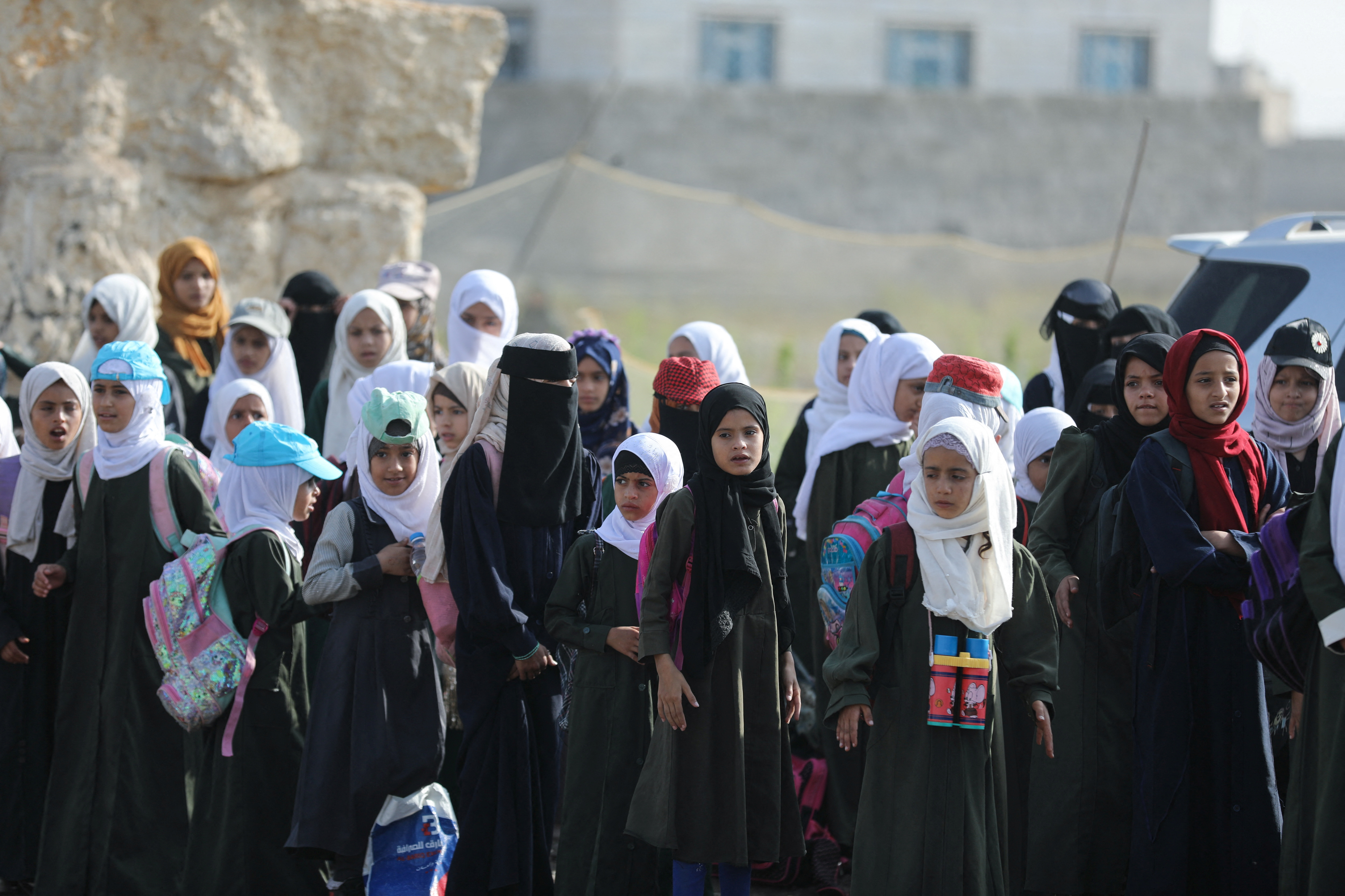 Students wait for the opening of a new school