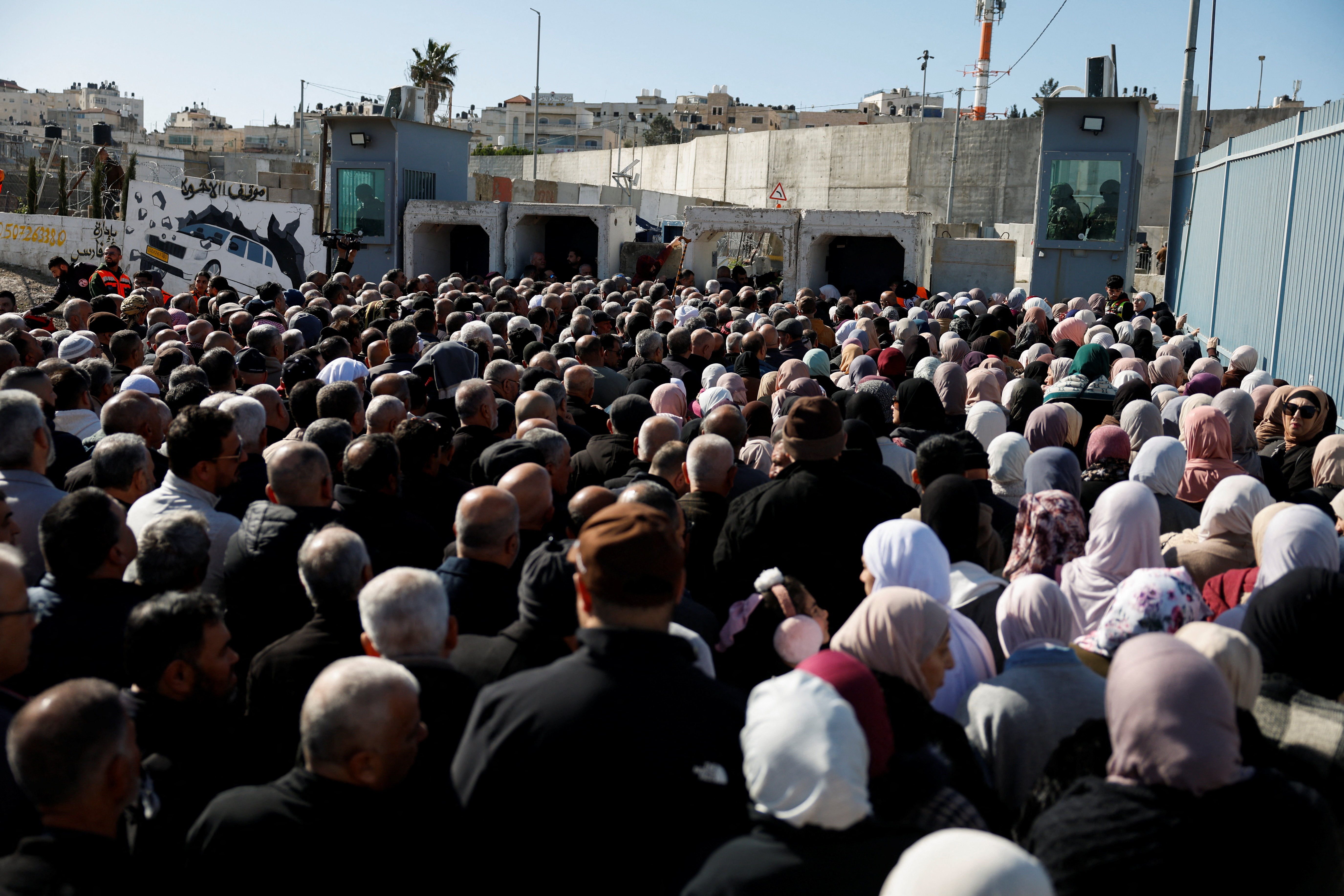 Palestinians make their way to Al-Aqsa compound, also known to Jews as the Temple Mount, in Jerusalem's Old City, to attend the first Friday prayers during the Muslim holy fasting month of Ramadan, near the Qalandia checkpoint in the Israeli-occupied West Bank, February 20, 2026. REUTERS/Mohammed Torokman