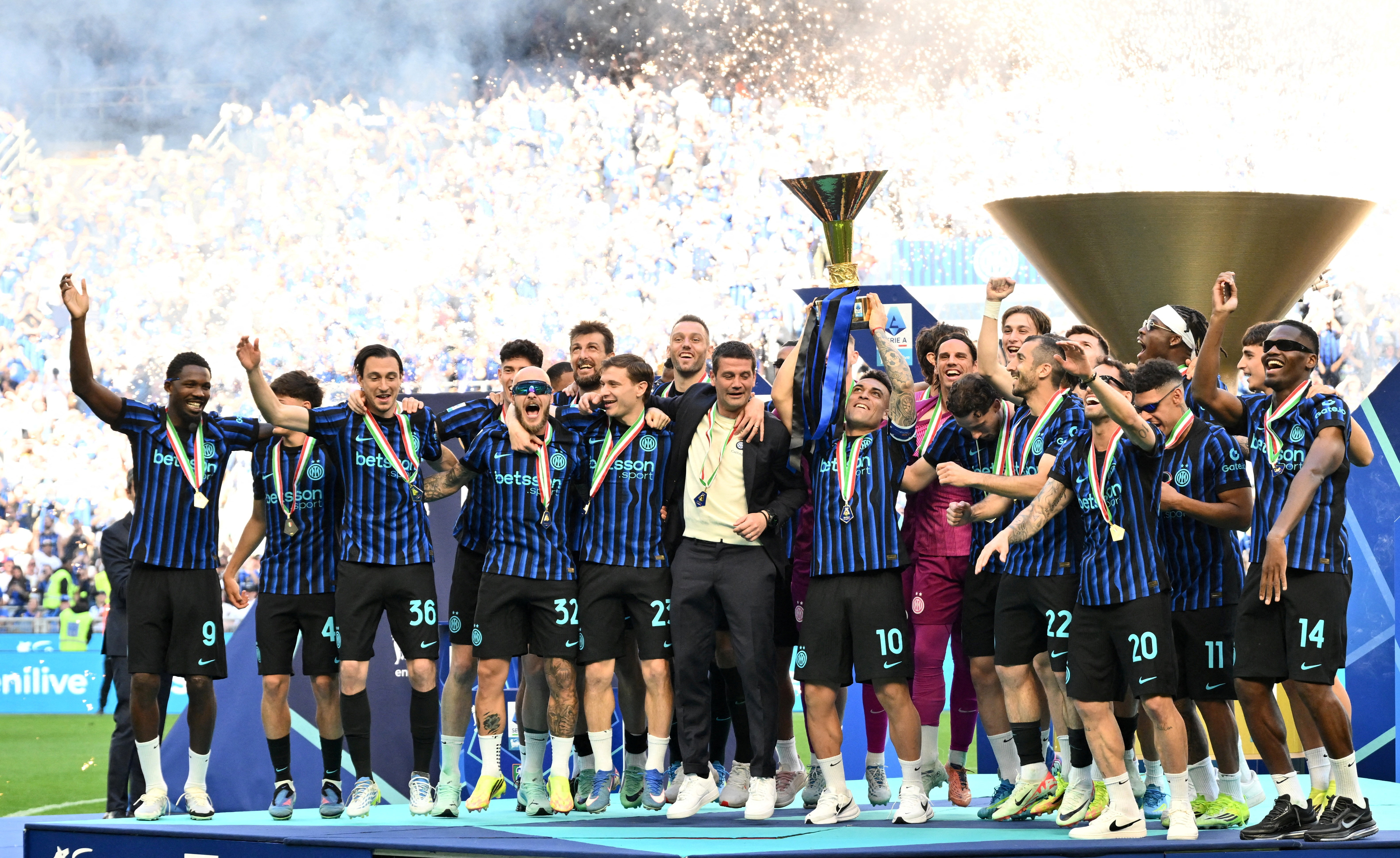 Inter Milan's Lautaro Martinez lifts the trophy as he celebrates with teammates after winning Serie A