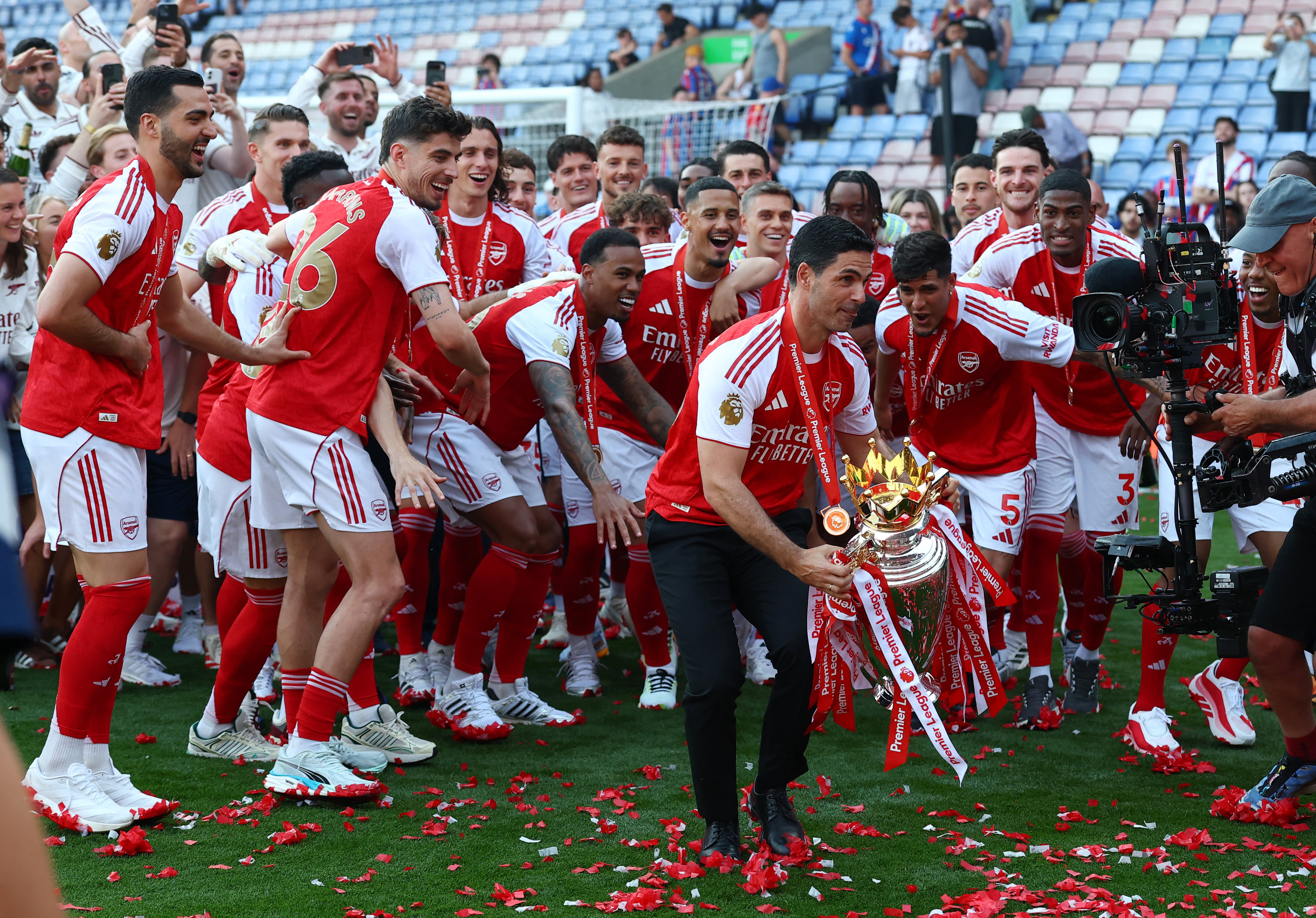 Arsenal Manager Mikel Arteta with the trophy as he celebrates with players after winning the Premier League last season
