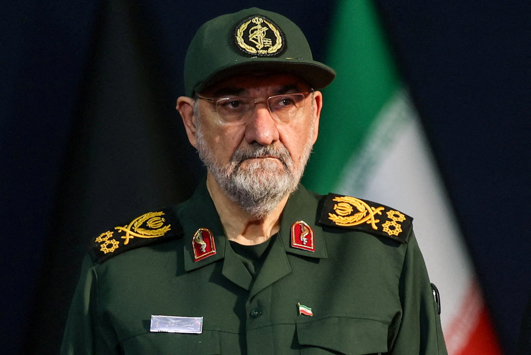 A man in a military outfit stands