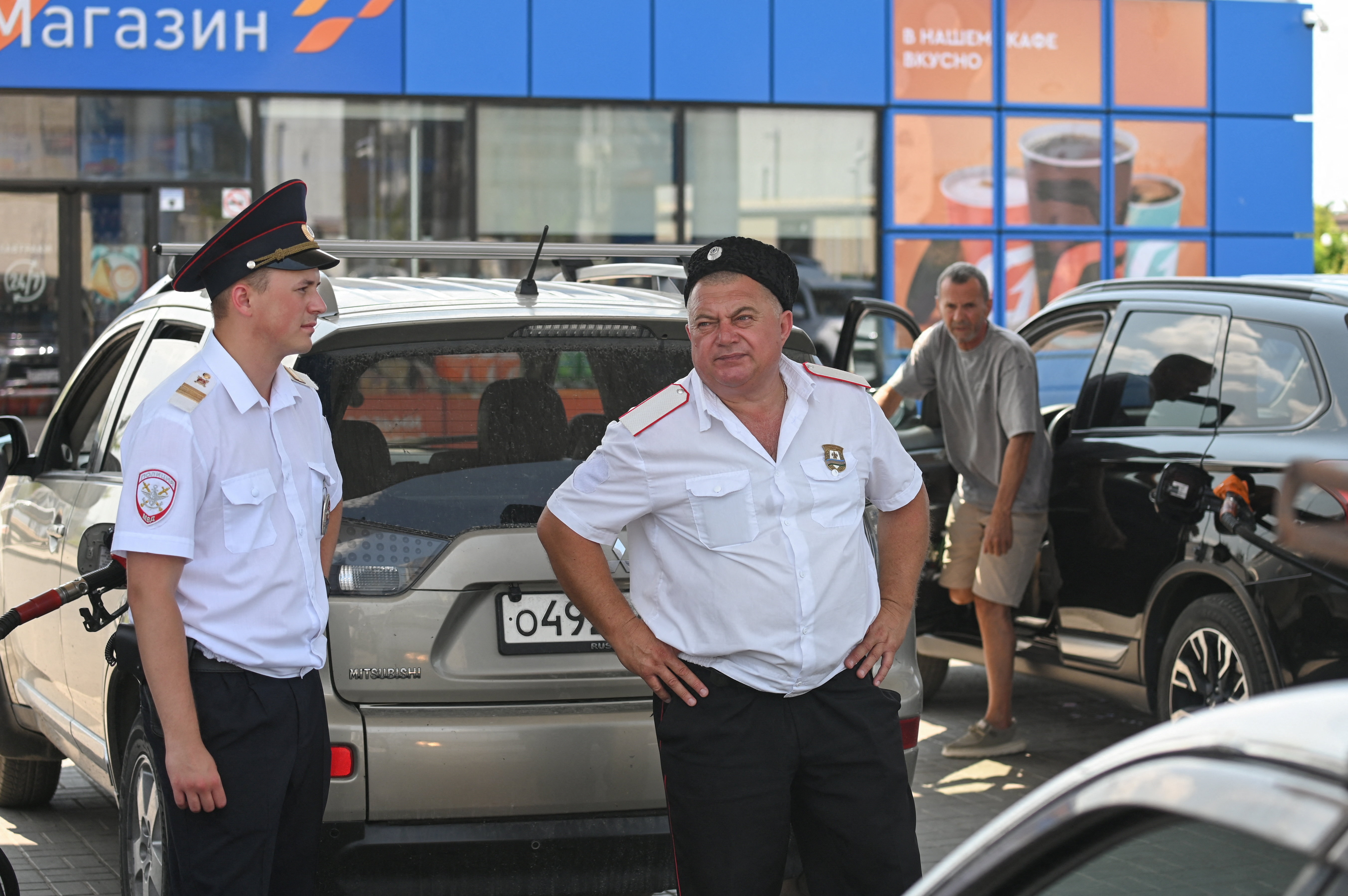 Cossacks keep order and prevent conflicts in a queue at a petrol station due to fuel shortage following a spate of Ukrainian attacks on oil refineries, amid the Russia-Ukraine conflict, in the Russian Black Sea resort of Anapa, Russia July 8, 2026. REUTERS/Sergey Pivovarov