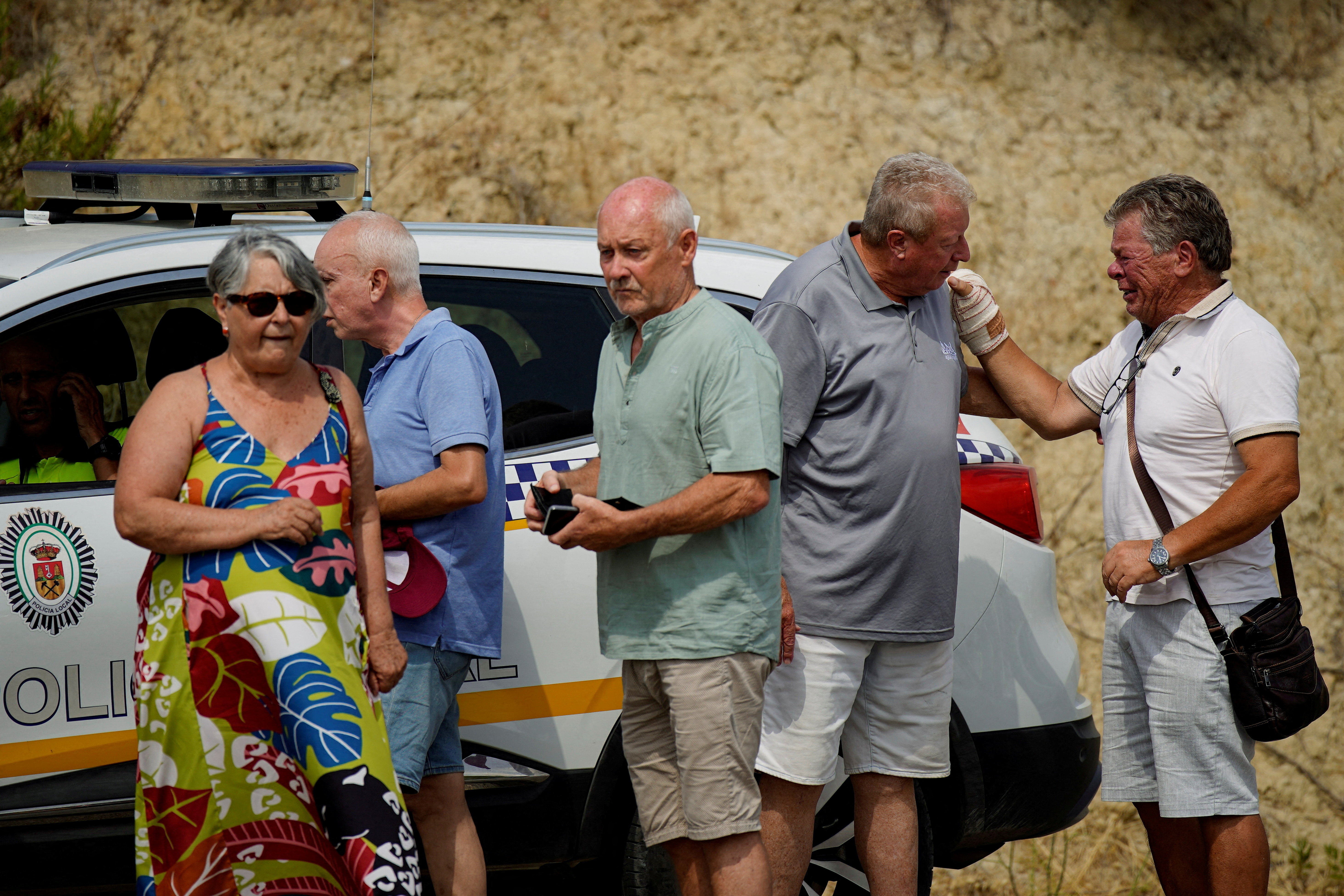Residents affected by deadly wildfires wait for access from police in order to return to their homes in Bedar, Almeria, Spain, July 12, 2026. REUTERS/Ana Beltran
