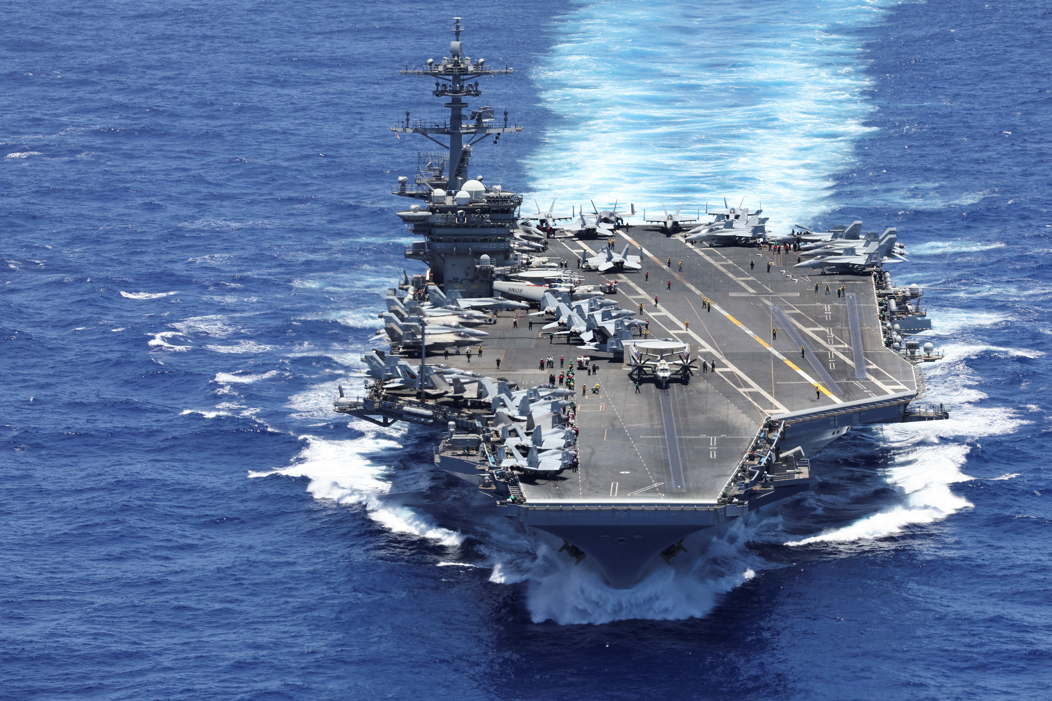 The USS Theodore Roosevelt from the bay doors of a V-22 Osprey after taking off during a Rim of the Pacific (RIMPAC) military exercise in waters south of the Hawaiian Islands, U.S., July 13, 2026. [Marco Garcia / Reuters]
