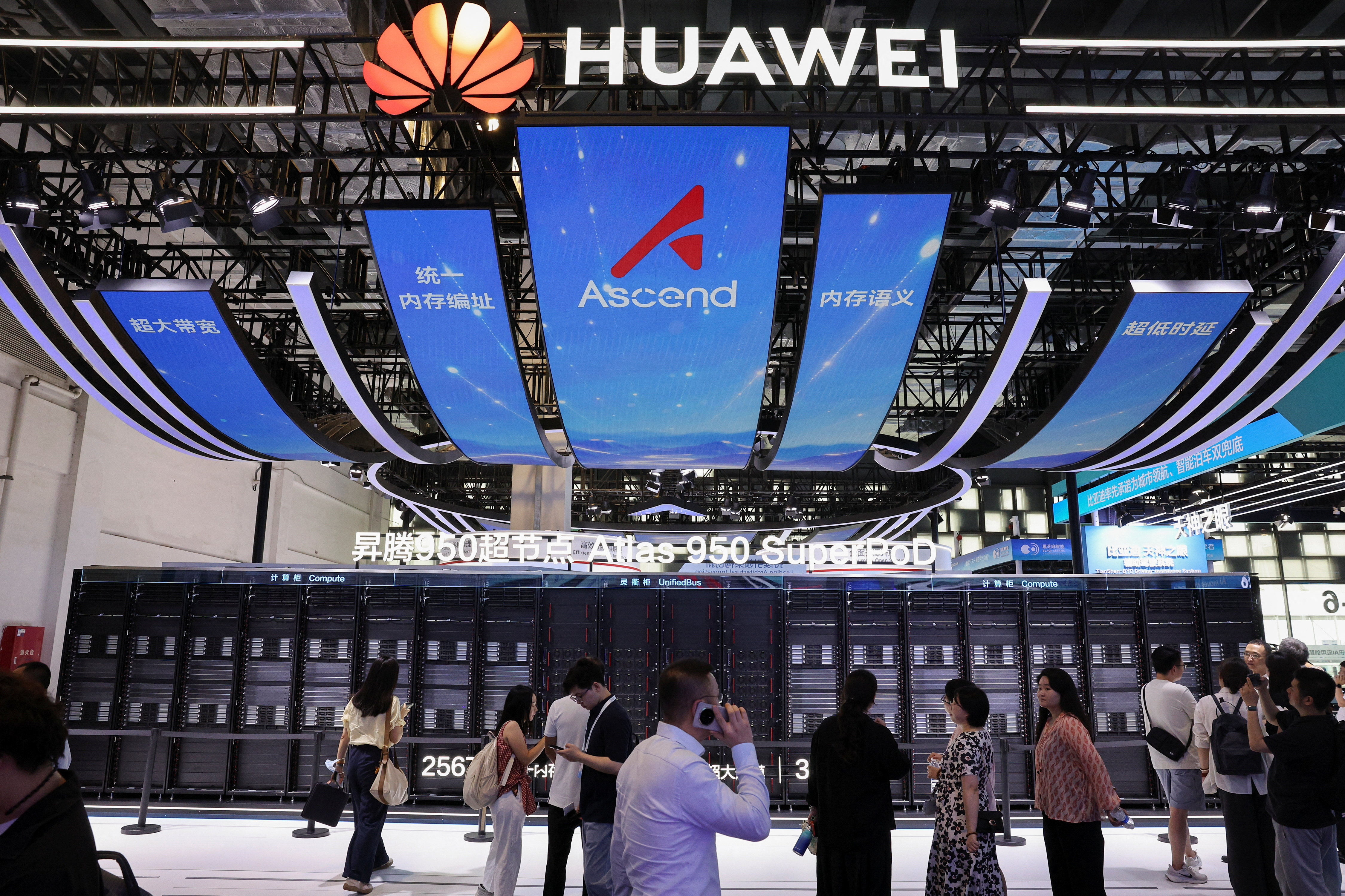 People walk past the Huawei booth, where the Atlas 950 SuperPoD system is displayed, during the World Artificial Intelligence Conference (WAIC) in Shanghai, China, on July 17, 2026. [Go Nakamura/Reuters]