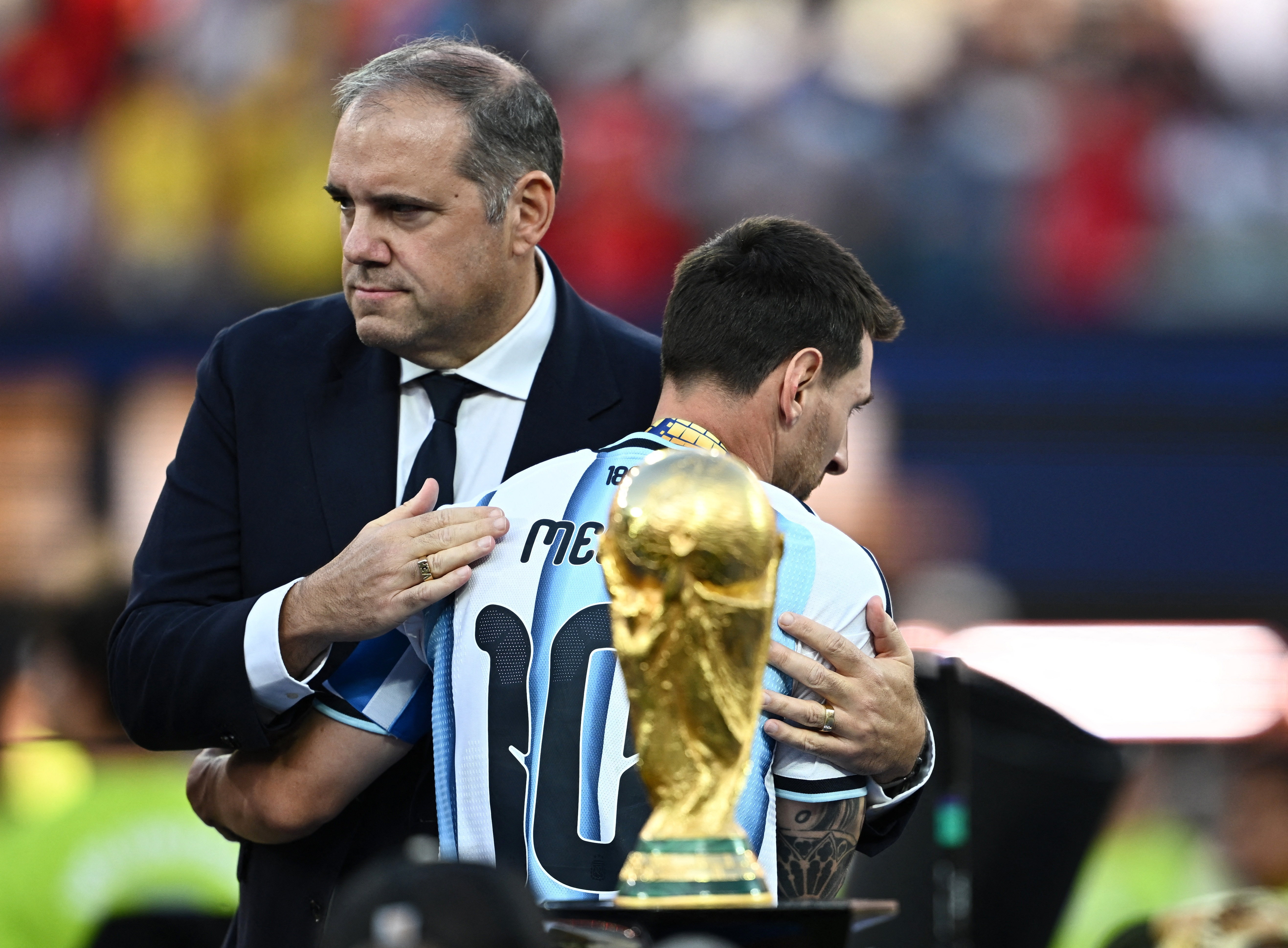 Argentina’s Lionel Messi embraces CONCACAF President Victor Montagliani after receiving his 2026 World Cup runners-up medal