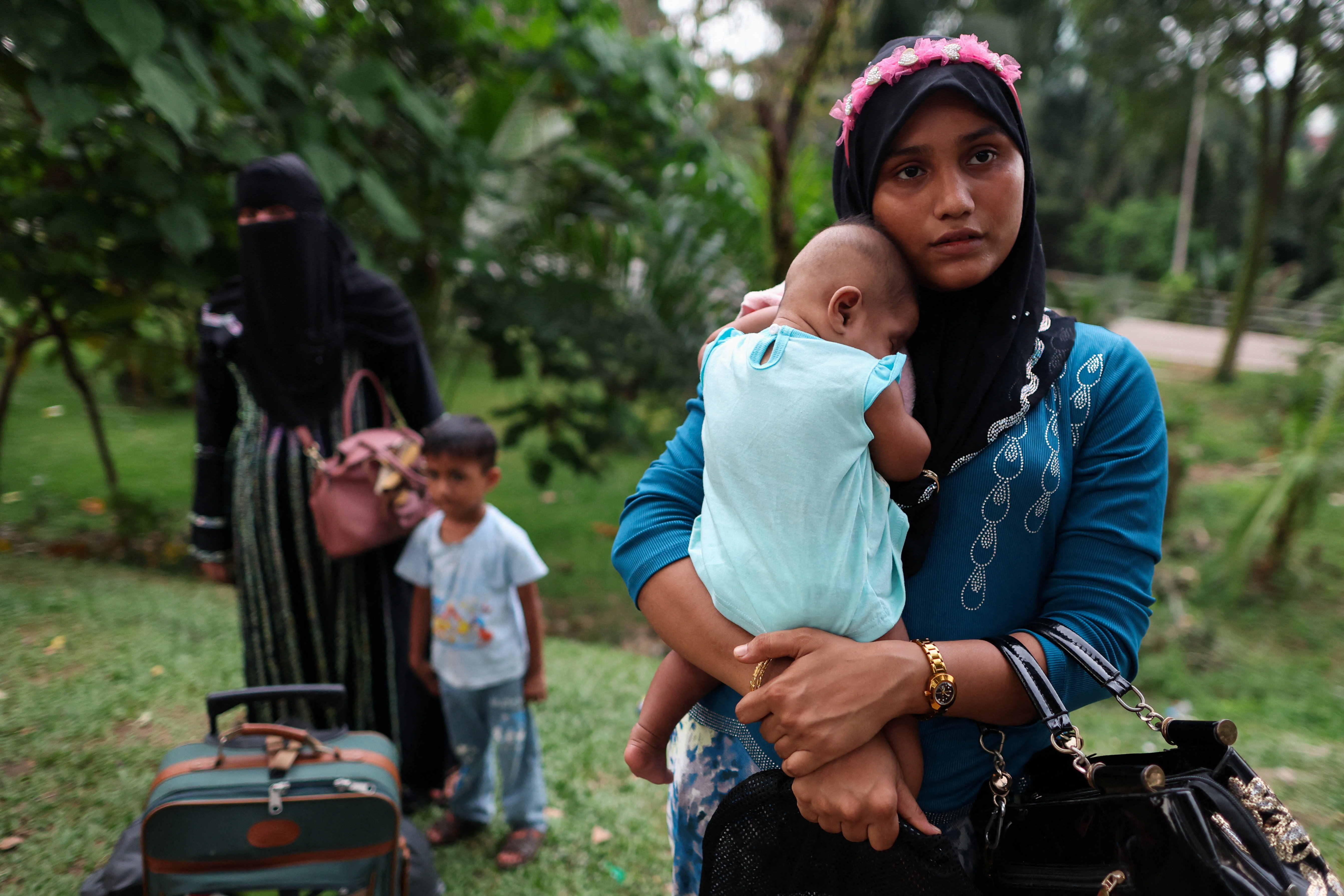 Rohingya refugees gather in front of the office of the U.N. refugee agency after being evicted from their homes