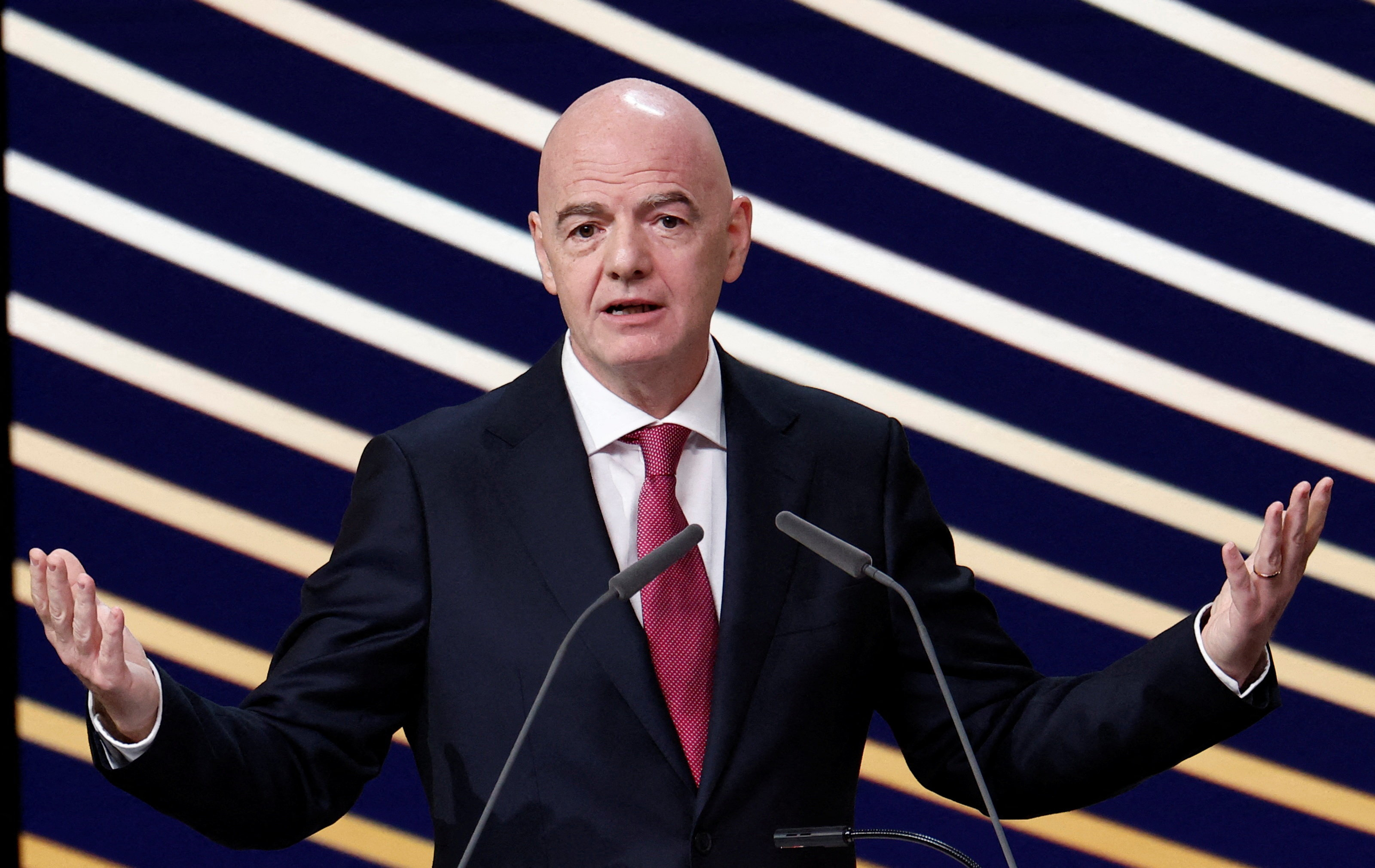 A man in a suit at a microphone