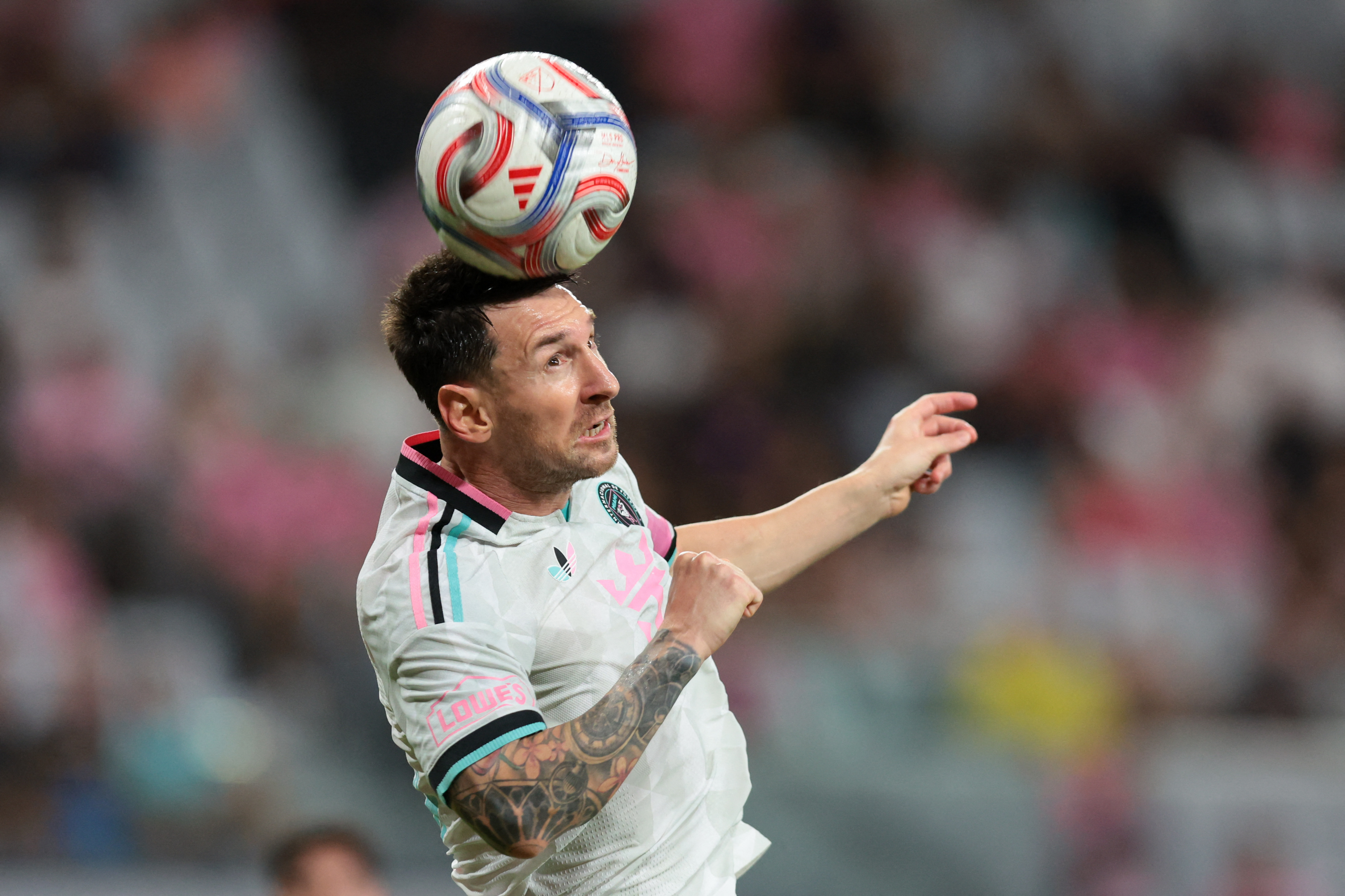 Lionel Messi heads the ball