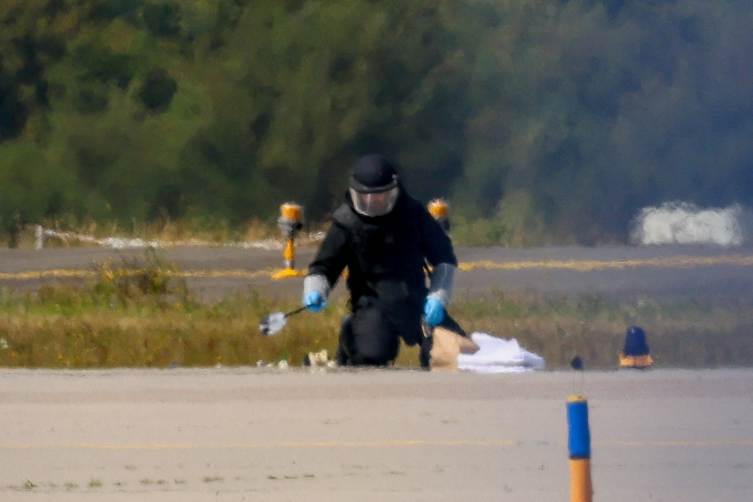 A police officer in protective clothing works at Leipzig/Halle airport in Schkeuditz, Germany