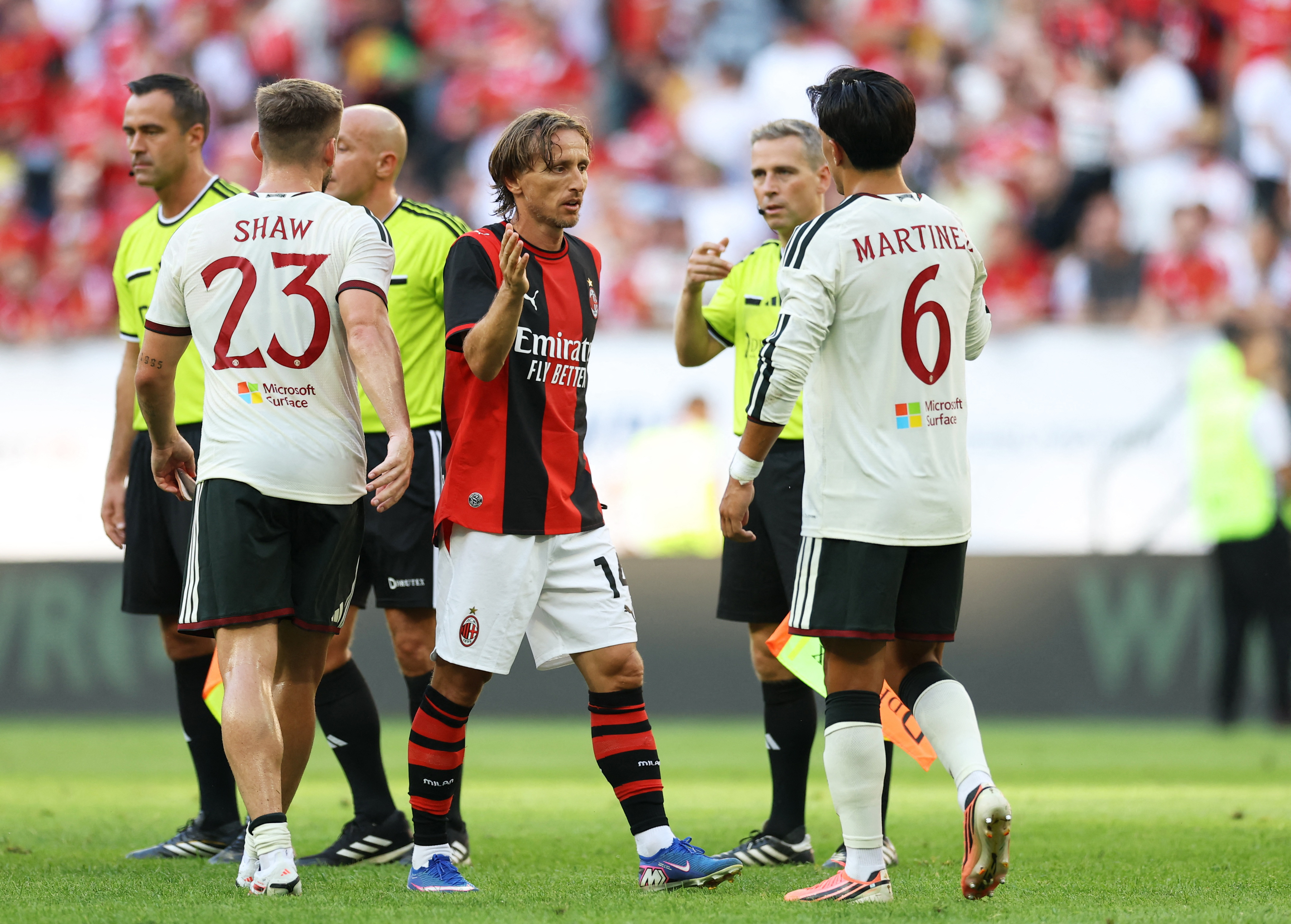 AC Milan’s Luka Modric shakes hands with Manchester United’s Lisandro Martinez after a preseason friendly in Poland