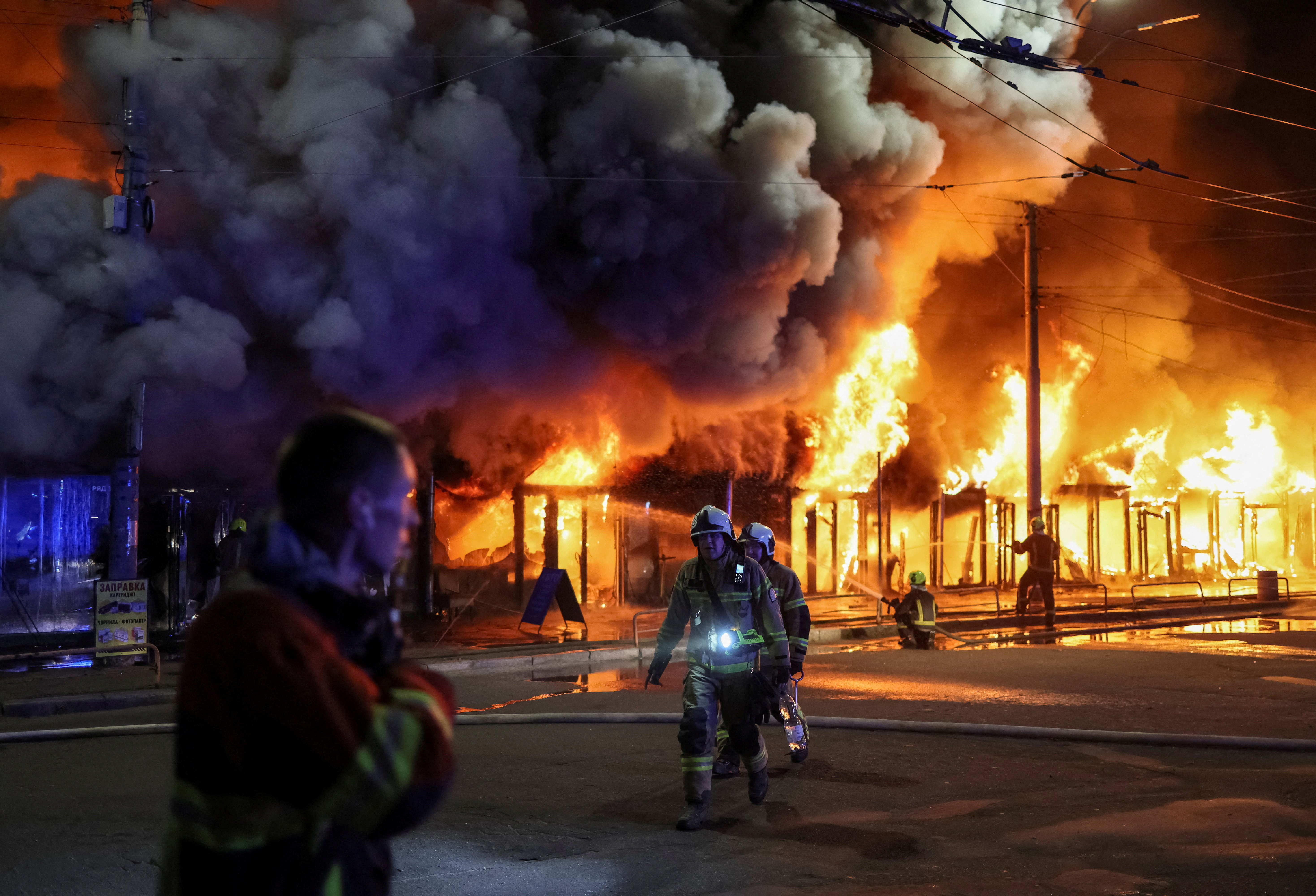 Firefighters work at a site of a book market hit by a Russian missile strike, amid Russia's attack on Ukraine, in Kyiv, Ukraine August 16, 2026. REUTERS/Gleb Garanich TPX IMAGES OF THE DAY REFILE - UPDATING LOCATION FROM "KYIV REGION" TO "KYIV".