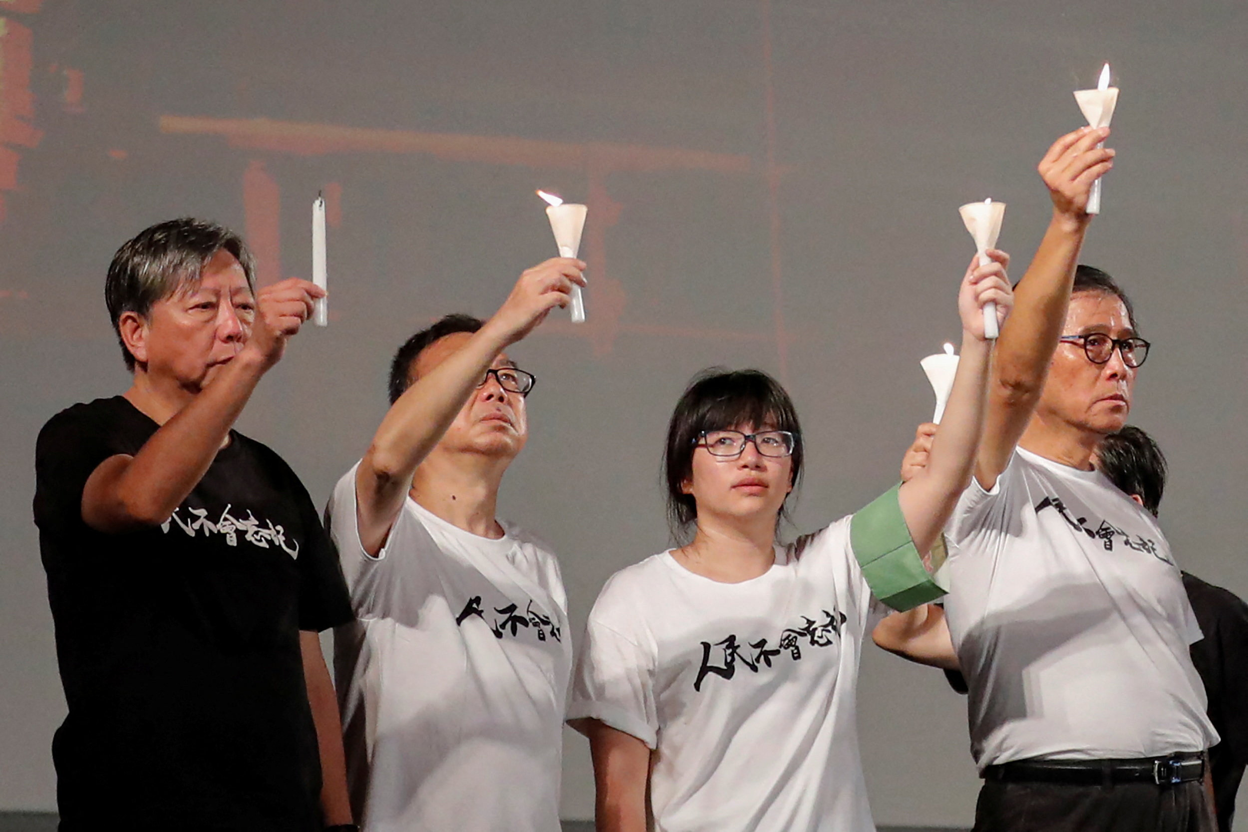 ro-democracy activists Lee Cheuk-yan, left, Cheung Man-kwong and Chow Hang-tung, centre right, at a 2019 vigil for the victims of the Tiananmen Square massacre. [File: REUTERS/Tyrone Siu]