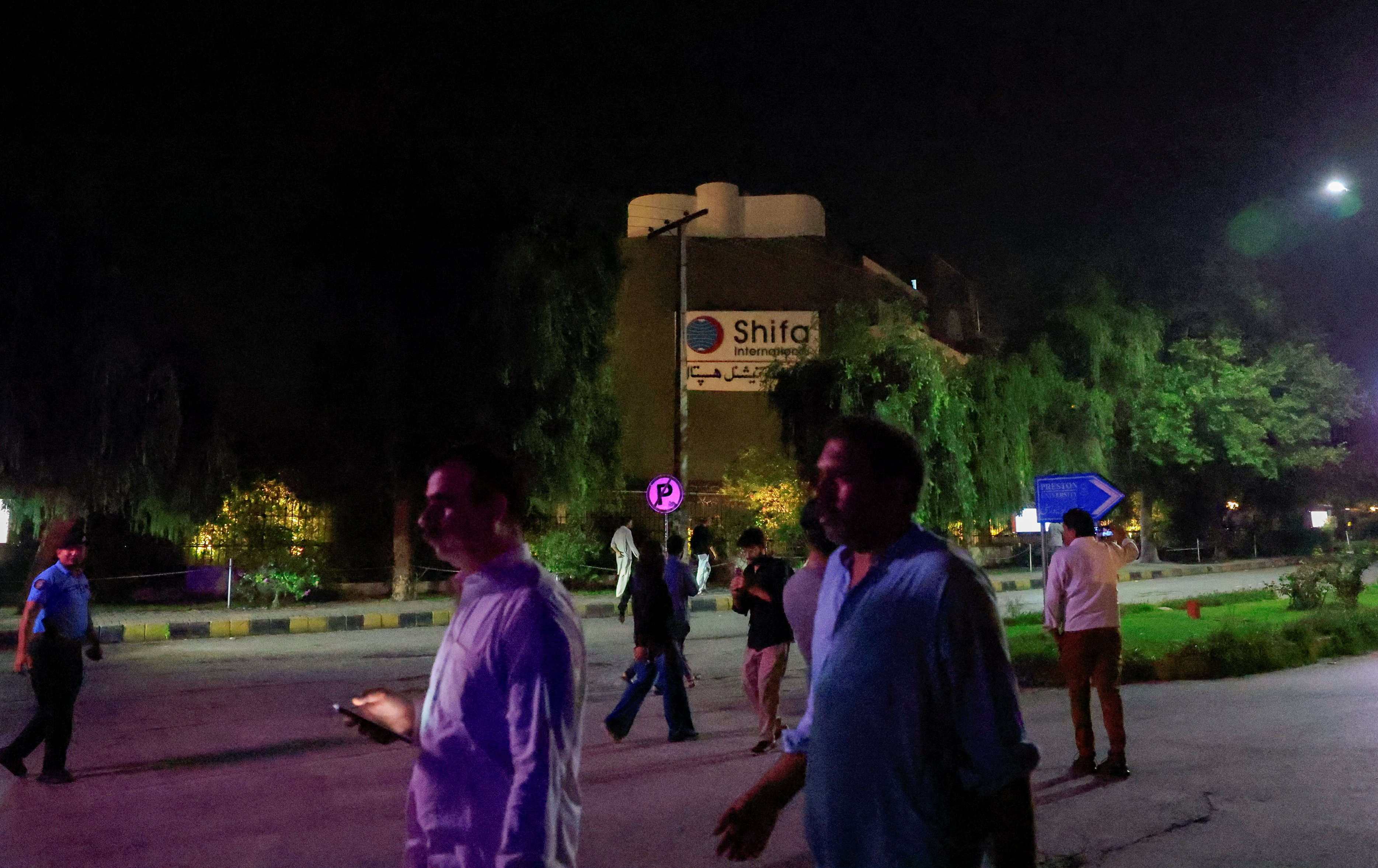 People walk past Shifa International Hospital after the Supreme Court ordered authorities to move jailed former Pakistani Prime Minister Imran Khan to the hospital, in Islamabad, Pakistan, August 20, 2026. REUTERS/Akhtar Soomro