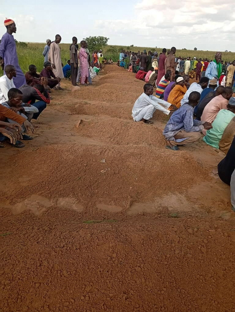 Mourners gather near the graves of victims who died in a boat accident, most of them children, in Gorau, Sokoto State, Nigeria, August 20, 2026 [Abubakar Imam/Reuters]