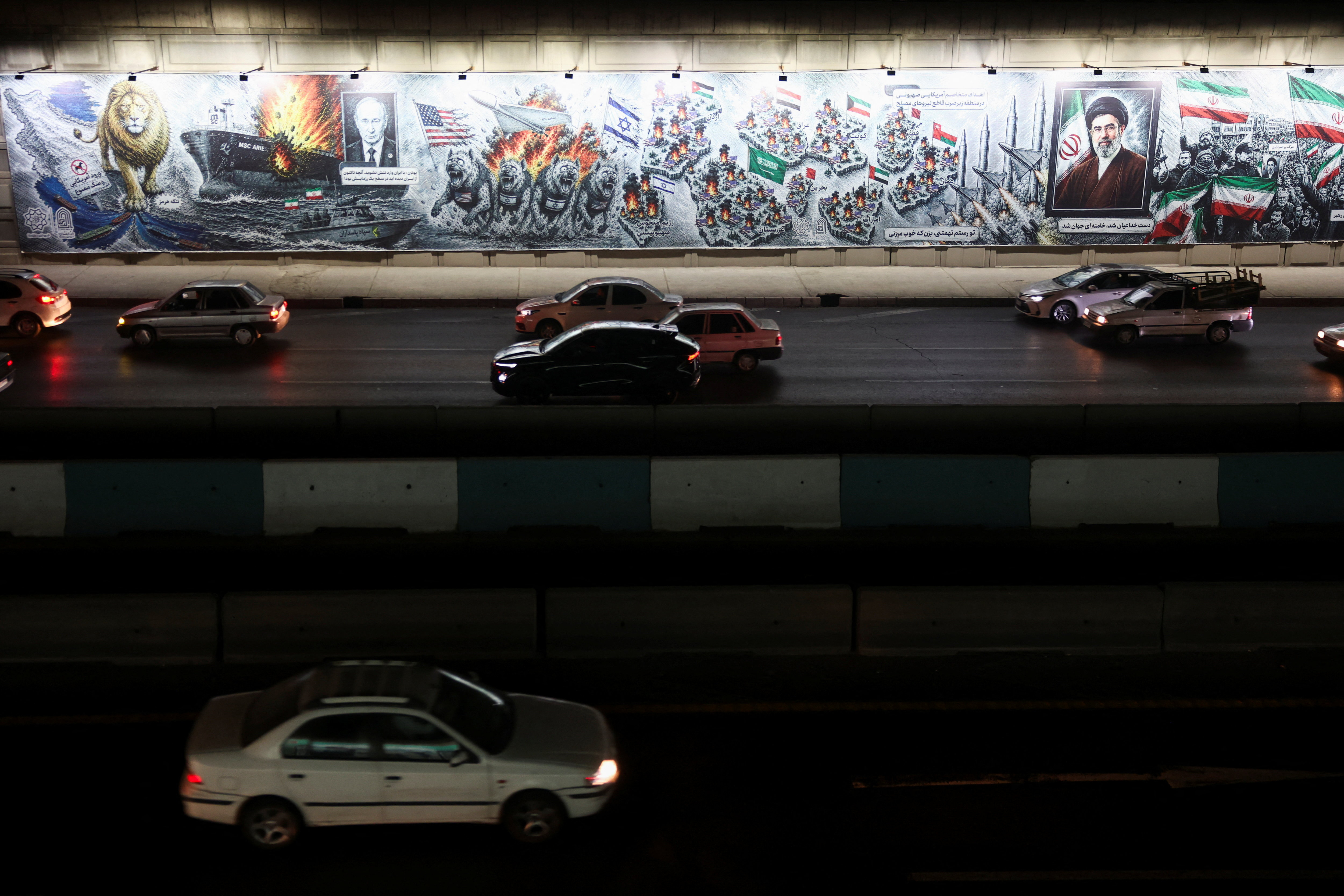 People drive past a billboard depicting Iran's Supreme Leader Mojtaba Khamenei, on a street in Tehran, Iran, August 23, 2026. Majid Asgaripour/WANA (West Asia News Agency) via REUTERS ATTENTION EDITORS - THIS PICTURE WAS PROVIDED BY A THIRD PARTY. ISRAEL OUT. NO COMMERCIAL OR EDITORIAL SALES IN ISRAEL. NO ACCESS FOR ISRAELI MEDIA. NO USE BBC PERSIAN. NO USE VOA PERSIAN. NO USE MANOTO. NO USE IRAN INTERNATIONAL. NO USE RADIO FARDA. DIGITAL: NO USE BBC PERSIAN. NO USE VOA PERSIAN. NO USE MANOTO. NO USE IRAN INTERNATIONAL. NO USE RADIO FARDA.