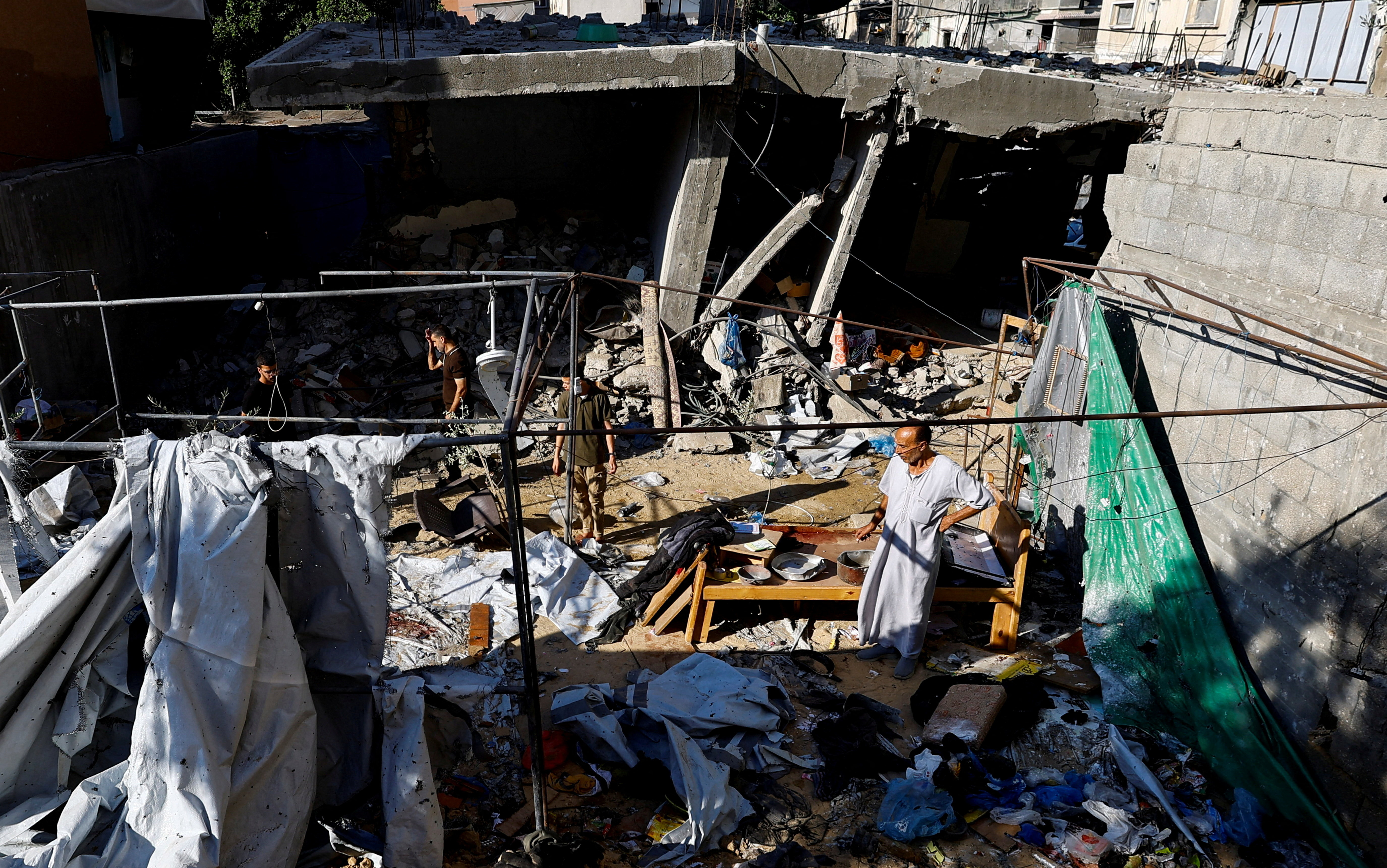 A Palestinian man inspects the site of an Israeli strike on a tent in Deir al-Balah, in the central Gaza Strip, August 24, 2026 [Mahmoud Issa/Reuters]