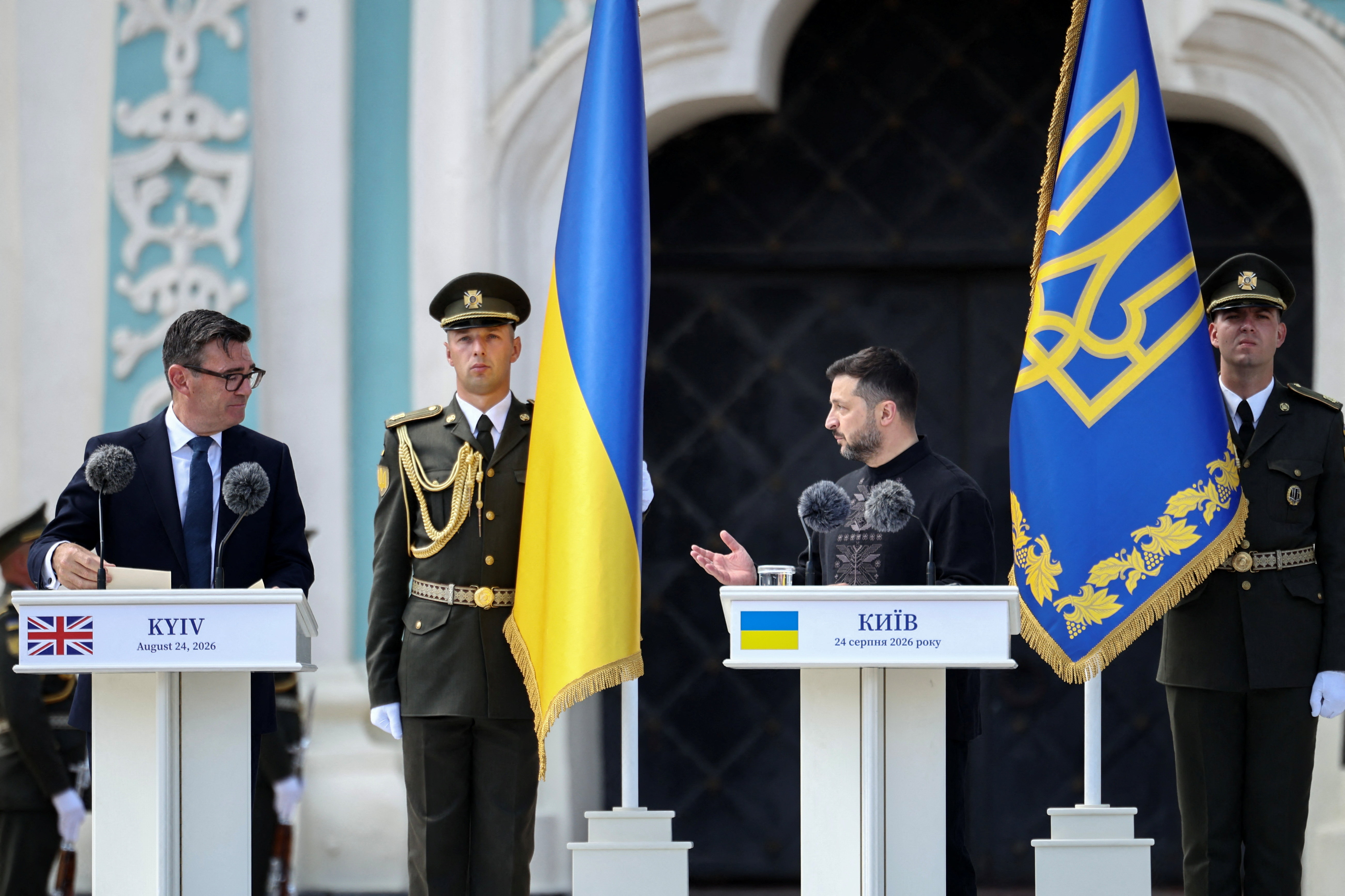 Britain's Prime Minister Andy Burnham looks at Ukraine's President Volodymyr Zelensky deliver a speech during a commemorative ceremony marking Ukraine's 35th Independence Day outside St. Sophia cathedral in Kyiv, Ukraine, August 24, 2026. HENRY NICHOLLS/Pool via REUTERS
