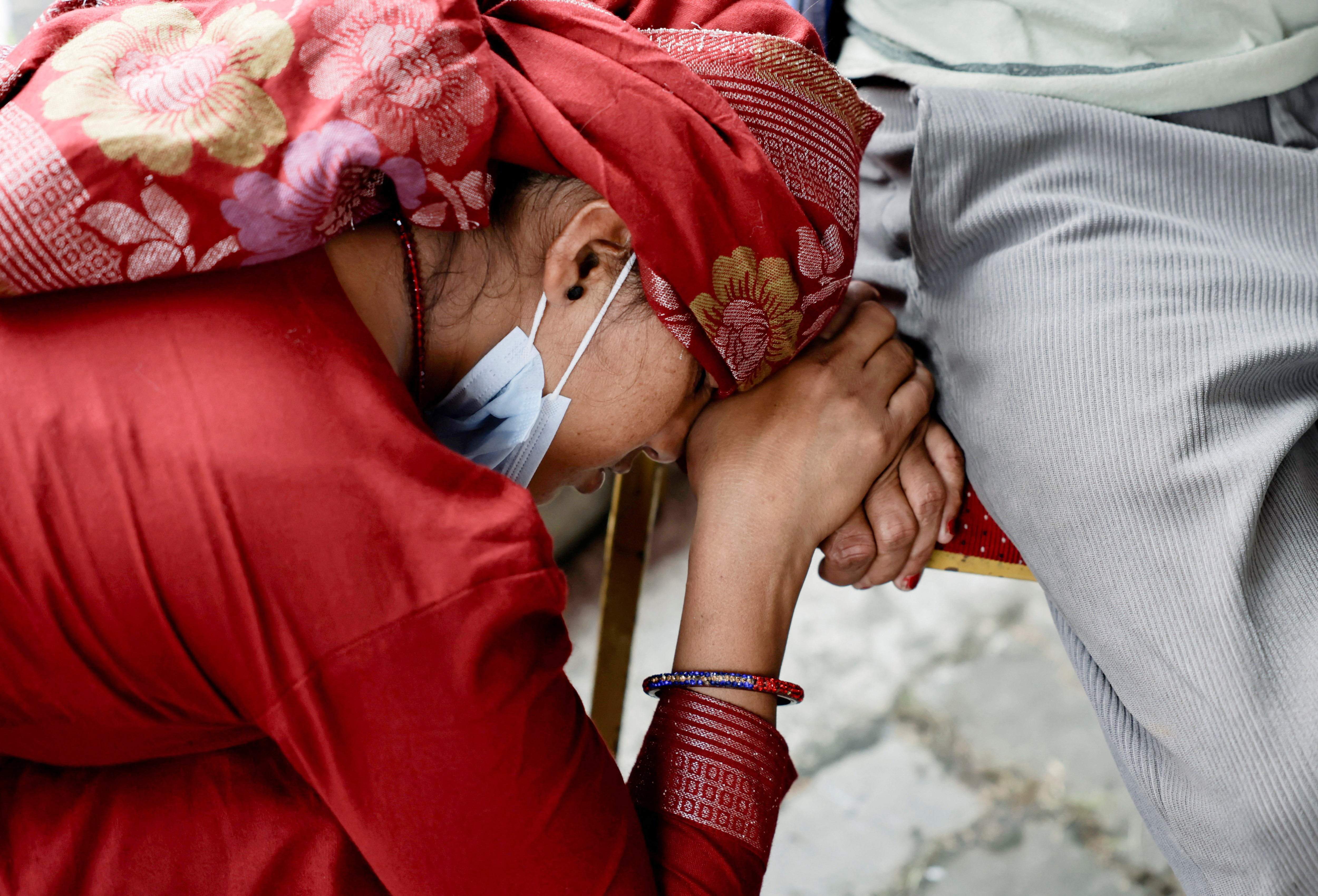 A woman waiting to identify her husband rests her head on a chair outside a temporary holding centre, where the bodies of victims are kept following devastating flash floods and a mudslide, in Bharatpur, Nepal August 30, 2026 [Navesh Chitrakar/Reuters]