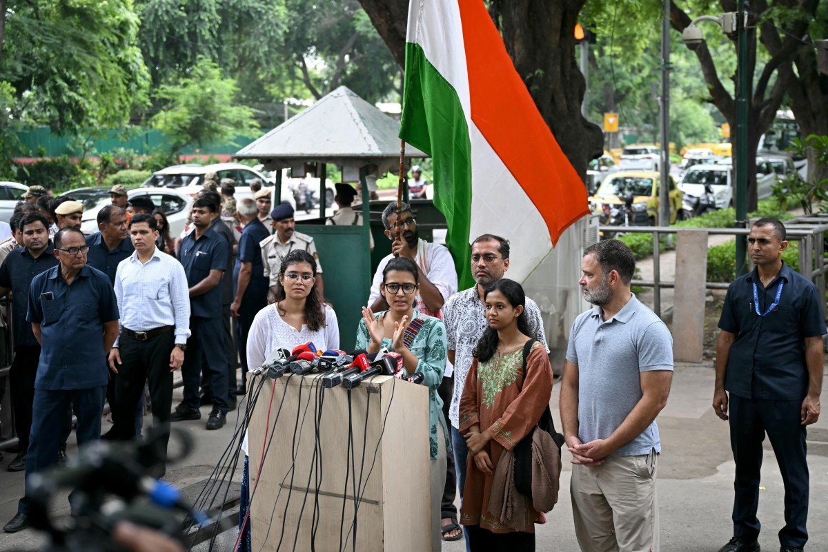 All India Students’ Association (AISA) President Neha Bora, centre, addresses a news conference alongside opposition leader Rahul Gandhi (second from right) in solidarity with the Cockroach Janta Party (CJP) in New Delhi on July 25, 2026, amid the ongoing protest demanding Education Minister Dharmendra Pradhan’s resignation over alleged NEET exam irregularities