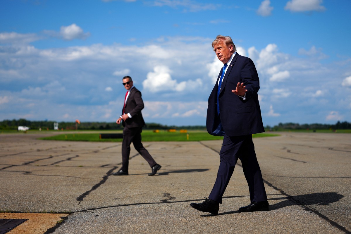 US President Donald Trump gestures after stepping off Air Force One upon arrival at Morristown municipal airport in Morristown, New Jersey, on July 31, 2026