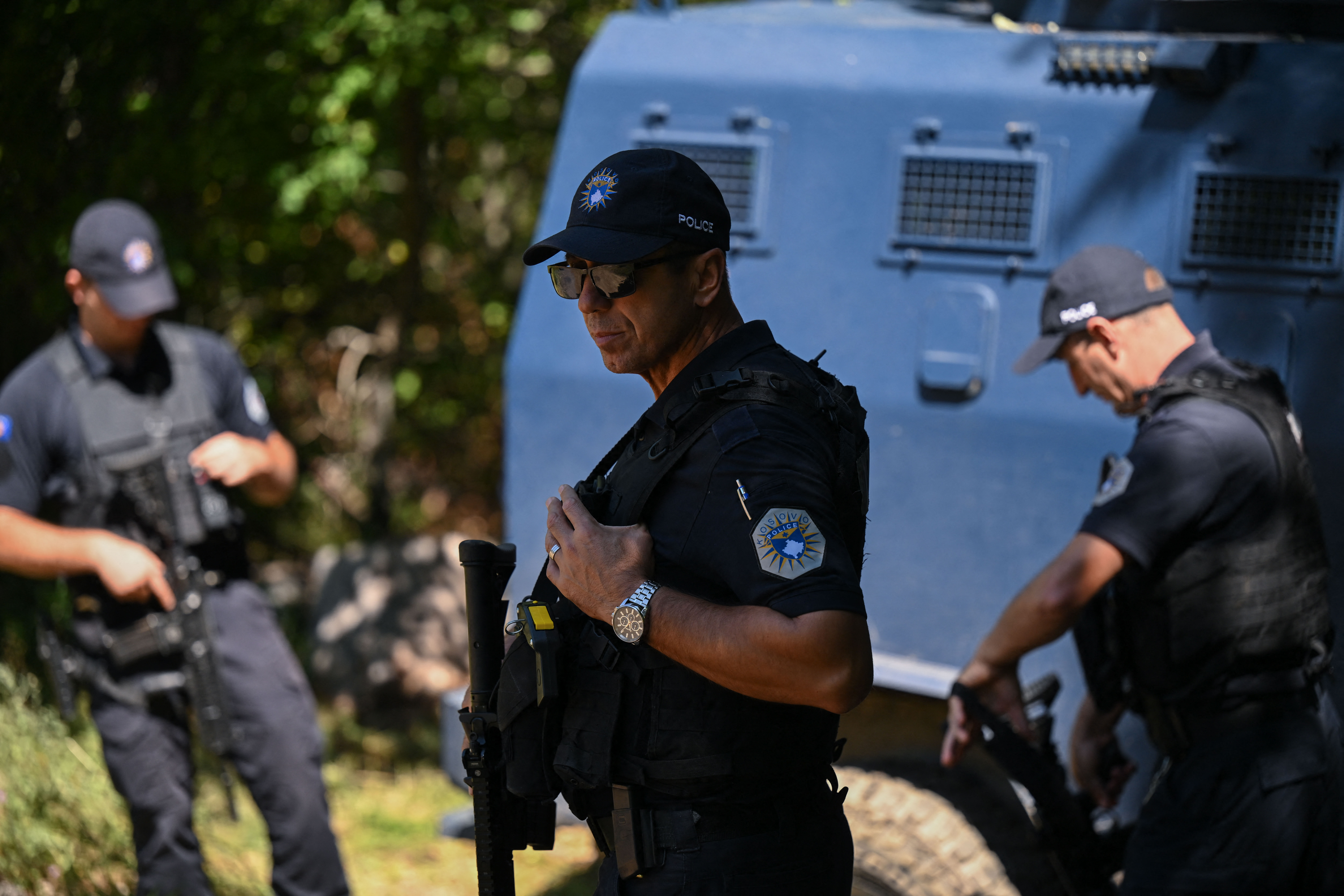 Kosovo police stand near a newly discovered possible mass grave site in the village of Kalluder, near the town of Zubin Potok, on August 1, 2026. [Armend Nimani/ AFP]