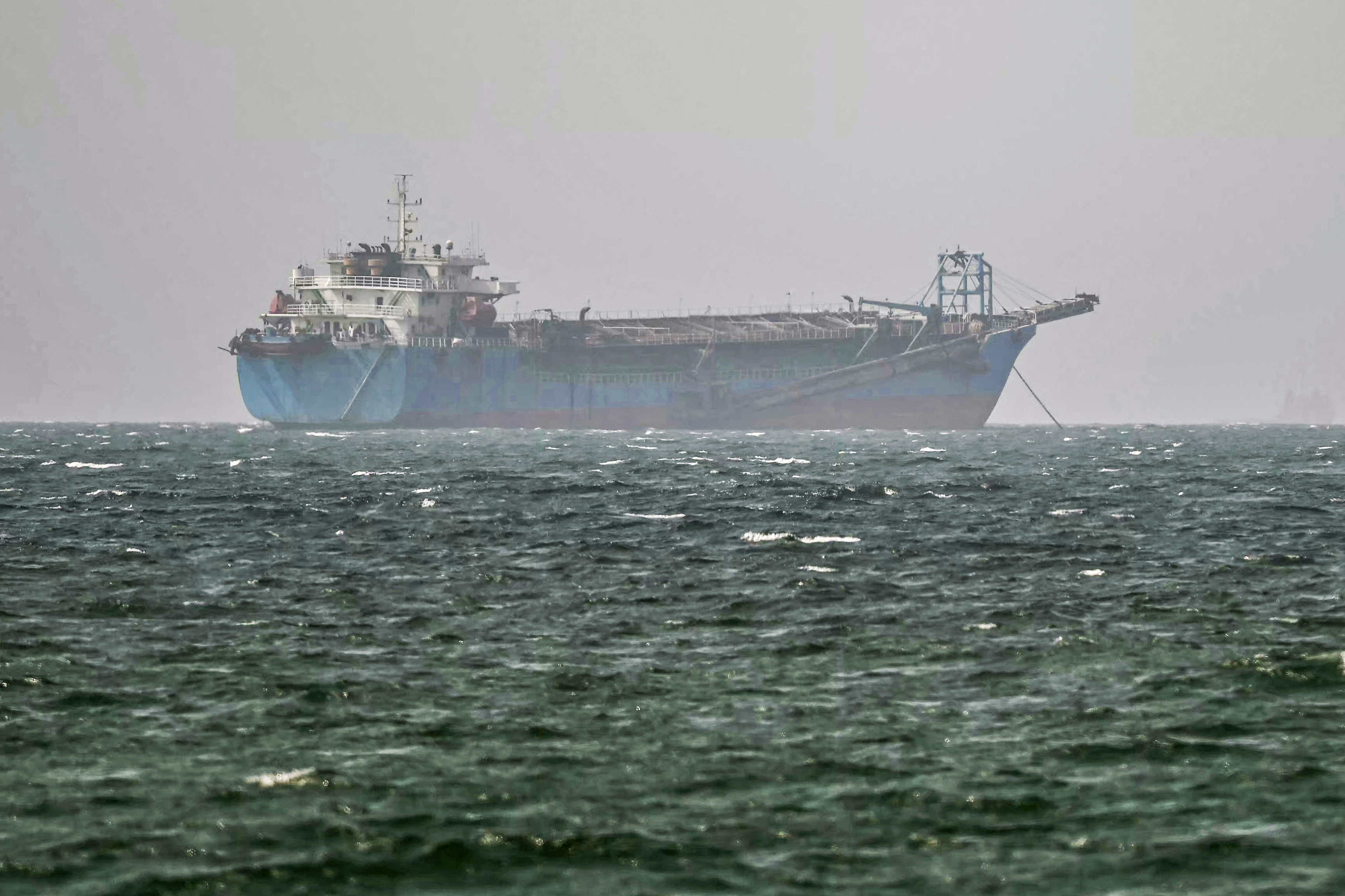 A vessel is anchored off the coast of Sharjah in the United Arab Emirates on August 3, 2026. Iran's foreign ministry said on August 3 there were currently no negotiations with the United States but talks were taking place with Oman on management of the strategic Strait of Hormuz. Iran has kept control of Hormuz since the outbreak of the war in the Middle East on February 28. (Photo by AFP) /