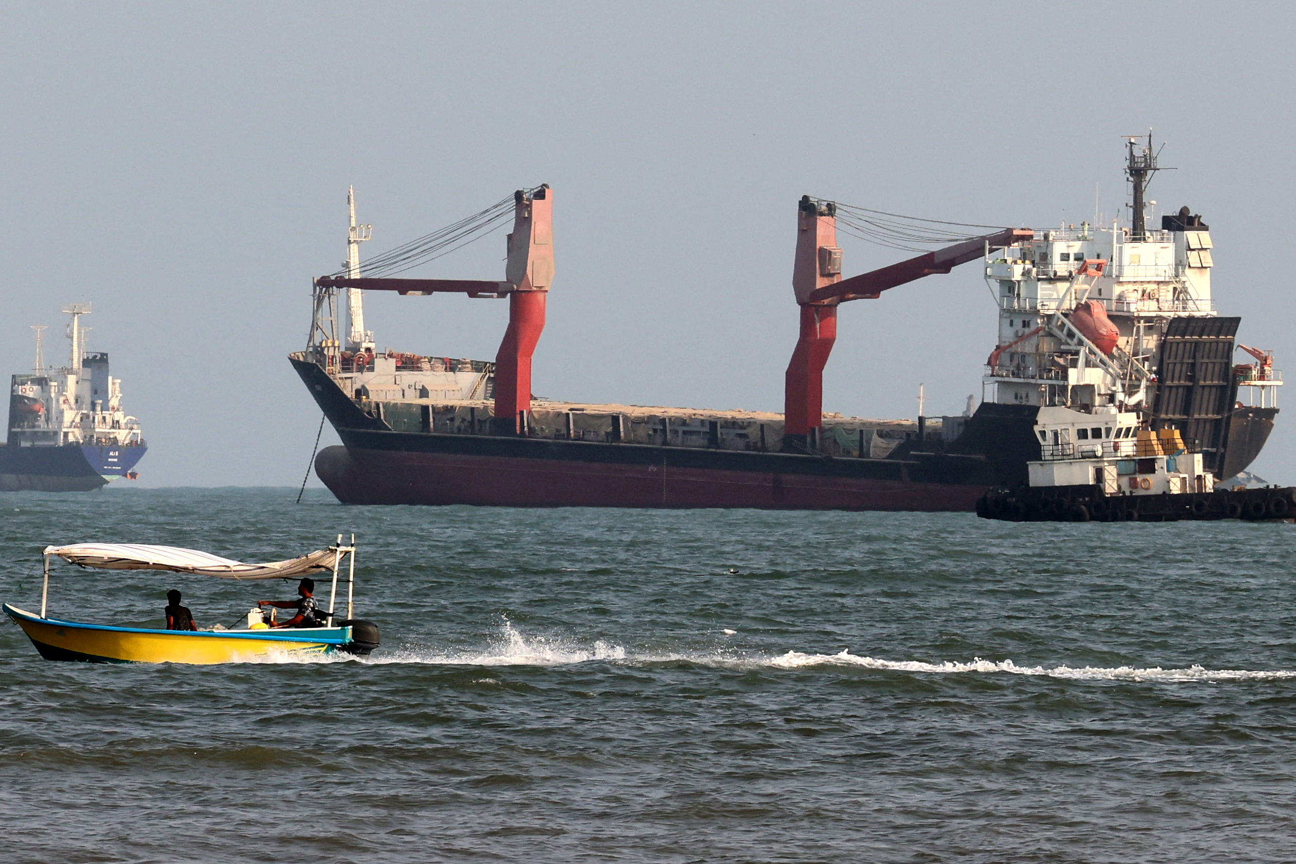 Vessels are seen in the Strait of Hormuz, off the port city of Bandar Abbas in southern Iran on August 10, 2026. The US President signalled on August 9 that he was prepared to let economic pressure mount against Iran, apparently backing away from more military strikes after Tehran issued a list of demands for opening the Strait of Hormuz. His remarks came after Iran issued over the weekend a list of conditions to reopen the Strait of Hormuz, which has remained largely closed since the start of the Middle East war in late February. (Photo by Atta KENARE / AFP) /
