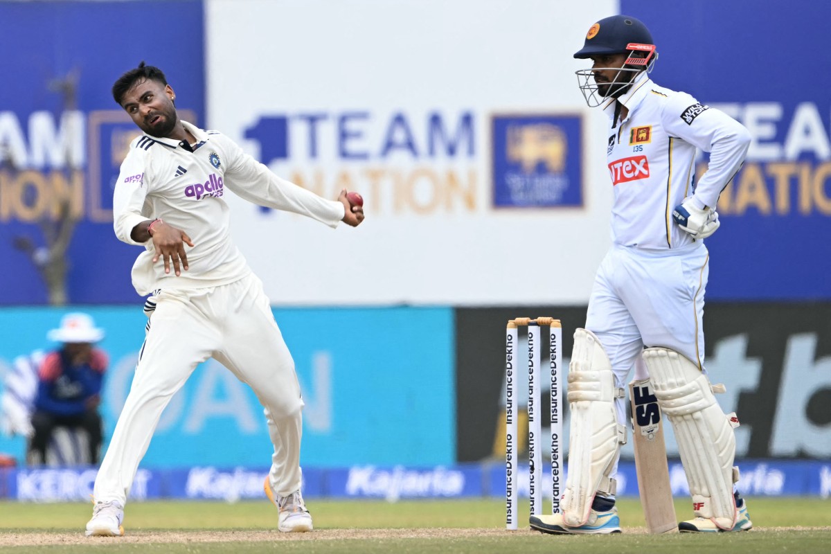 India's Manav Suthar (L) bowls during the third day of the first Test cricket match between Sri Lanka and India
