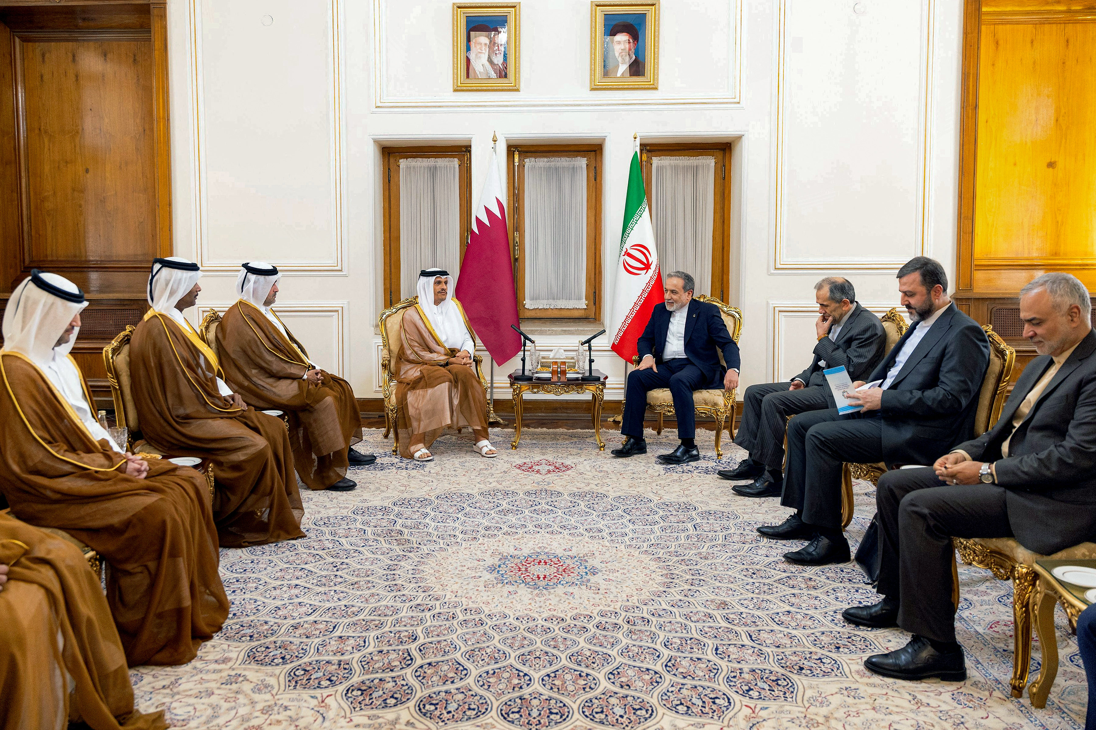 This handout picture released by the Qatari Ministry of Foreign Affairs shows Qatar's Prime Minister and Foreign Minister Sheikh Mohammed bin Abdulrahman bin Jassim Al-Thani (C-L) and his delegation meeting with Iran's Foreign Minister Abbas Araghchi (C-R) in Tehran on August 27, 2026.