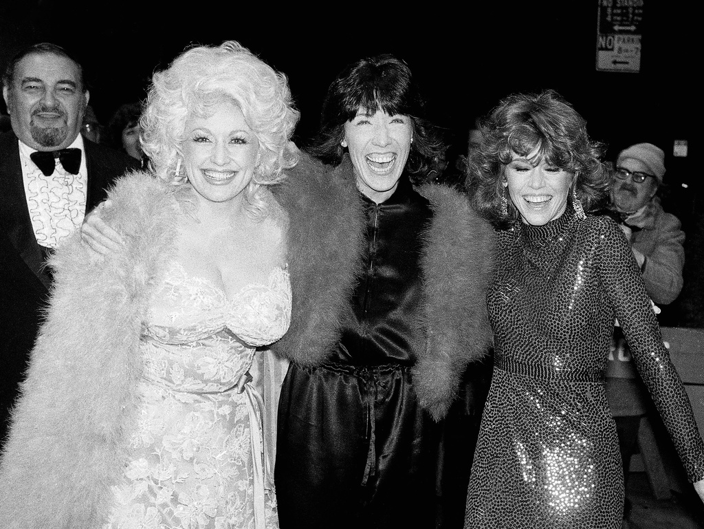 Dolly Parton, left, Lily Tomlin, centre, and Jane Fonda, right, arrive for the premiere of their film “9 To 5” in New York City, New York, on December 14, 1980