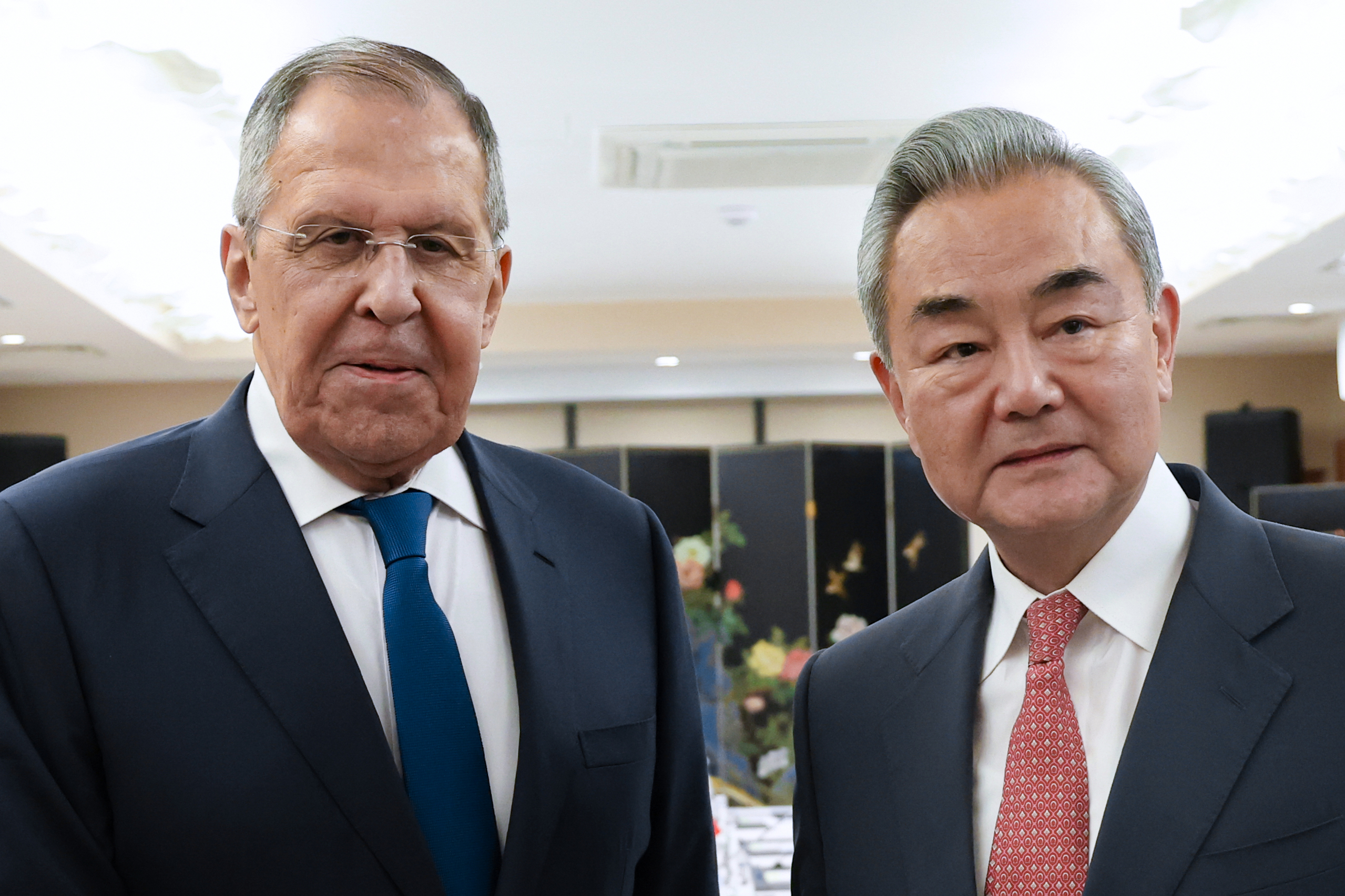 Russian Foreign Minister Sergey Lavrov, left, and Chinese Foreign Minister Wang Yi pose for a photo.