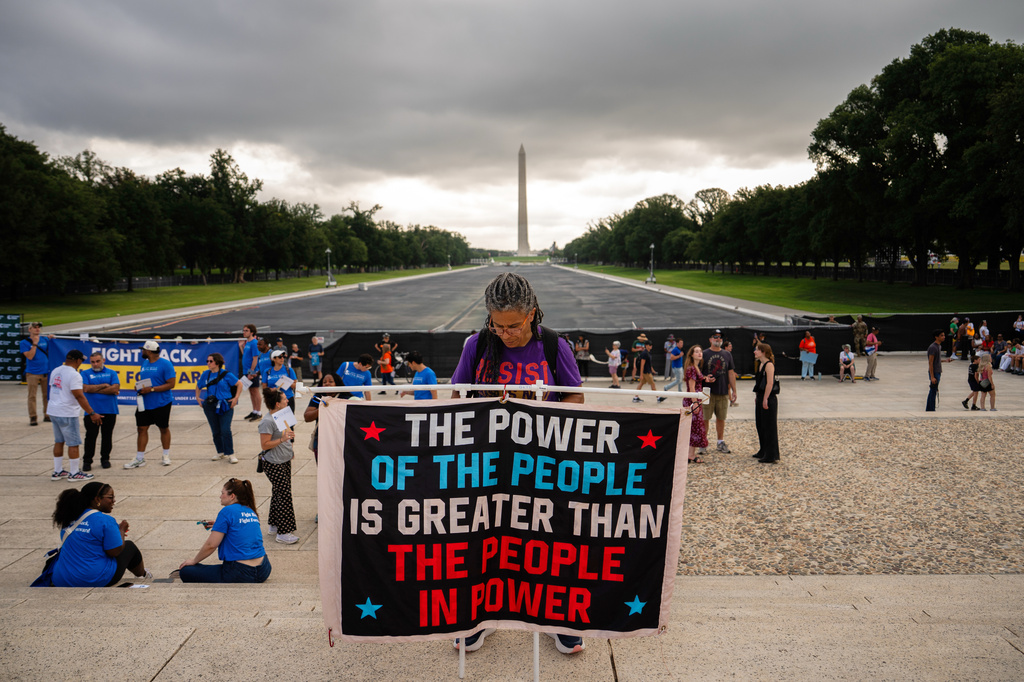 a protester stands in front of the Lincoln Memorial