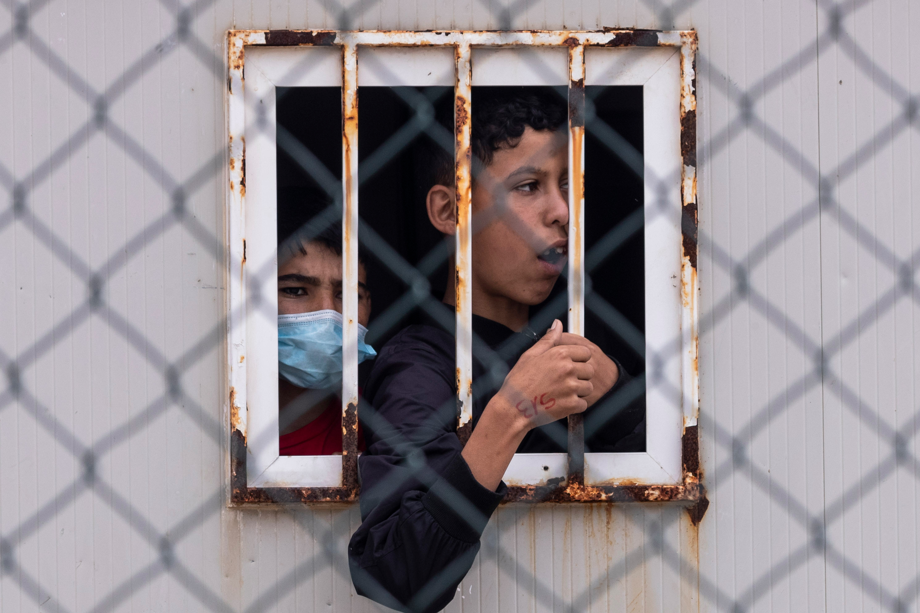 Children who crossed into Spain wait inside a temporary shelter for unaccompanied minors in the enclave of Ceuta, next to the border of Morocco and Spain, Thursday, May 20, 2021. (AP Photo/Bernat Armangue)