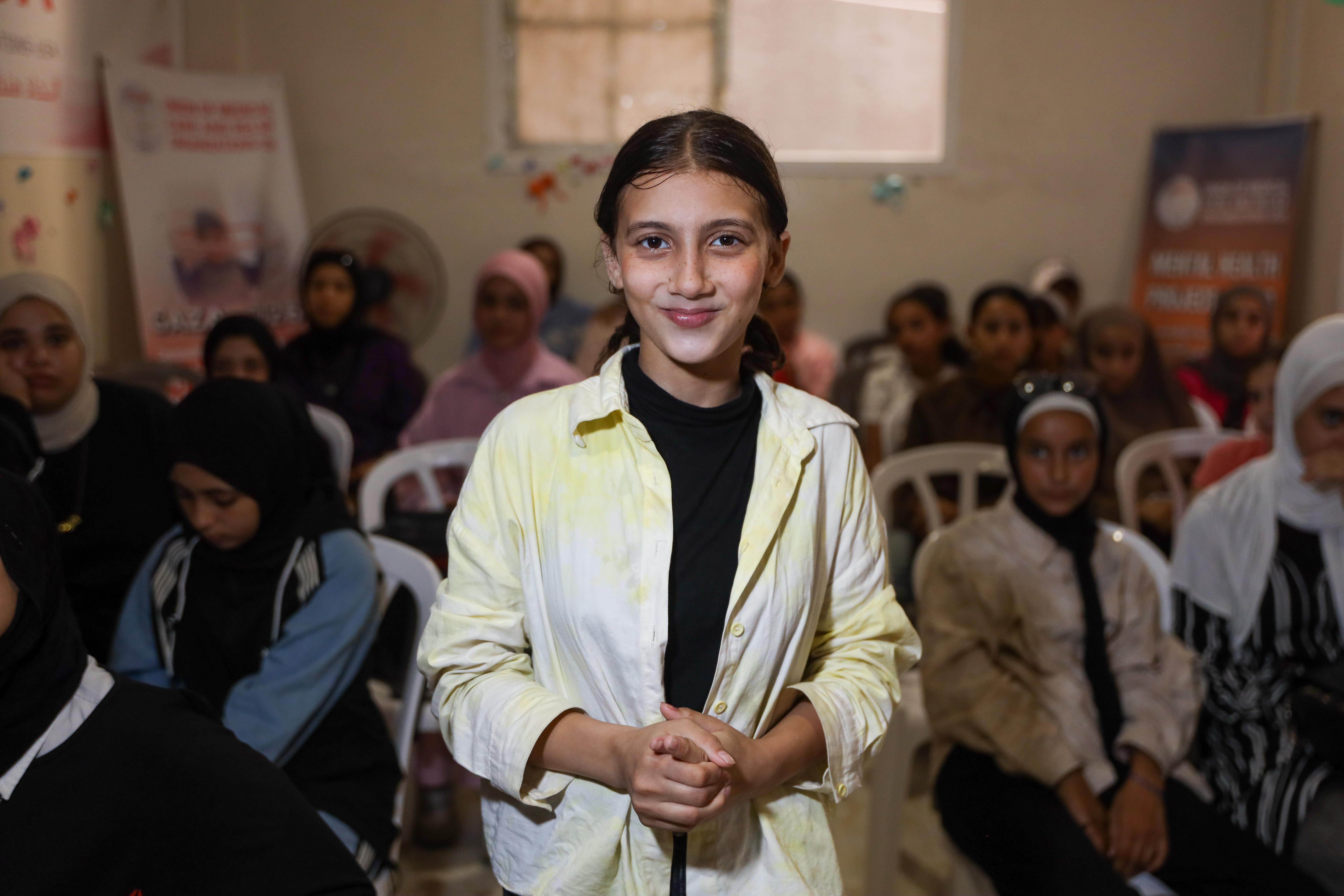 Natalie Al-Hatoum, 14, comes to the weekly cinema activity to enjoy the film and spend time away from the pressures of displacement [Abdelhakim Abu Riash/ Al Jazeera]