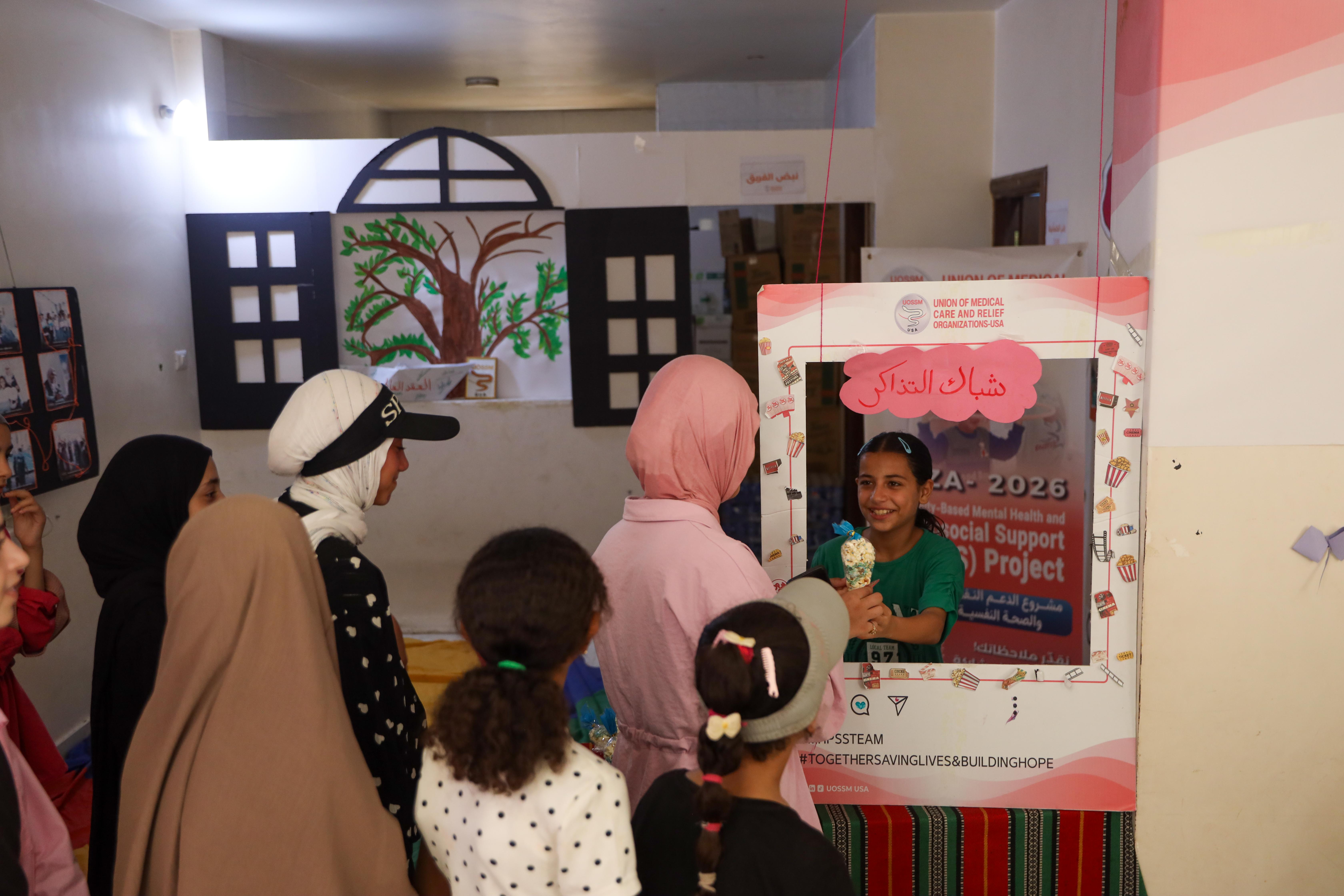 Popcorn and mock cinema tickets help recreate the experience of going to a movie theatre for displaced girls [Abdelhakim Abu Riash/ Al Jazeera]