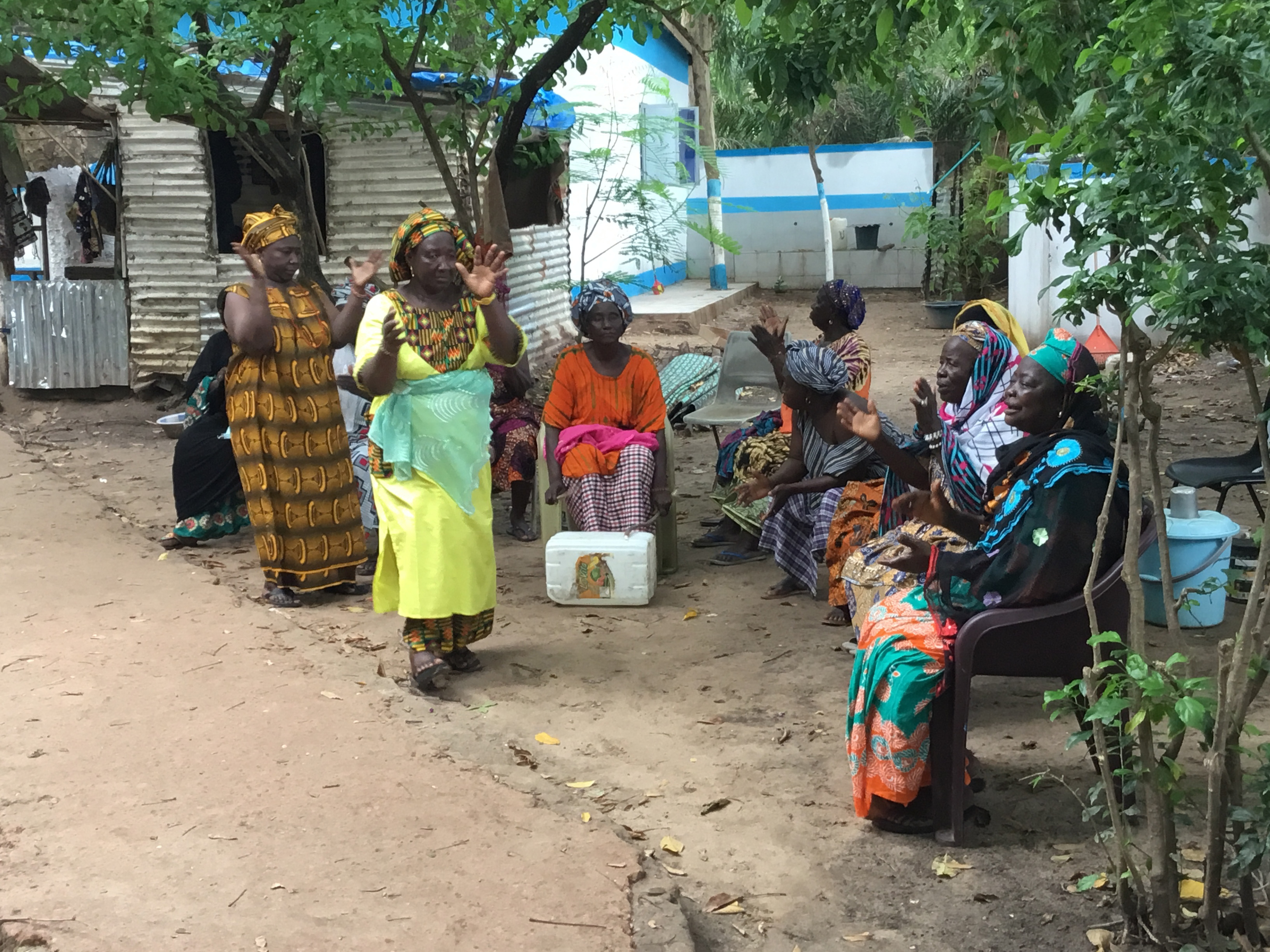 Members of the Bakau Kanyeleng share a moment together between songs and performances