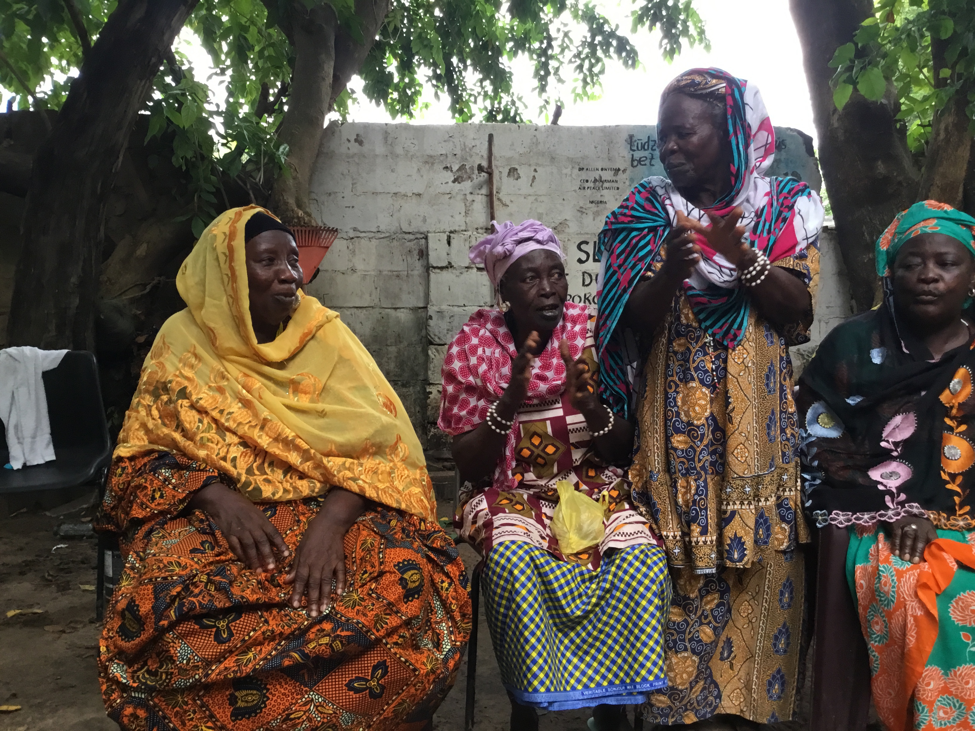 Tida Fofana, centre, sits among fellow Kanyeleng members during one of the group’s regular gatherings in Bakau