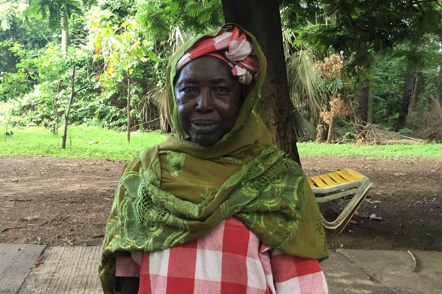 Nanding, 72, a member of the Kanyeleng group in Bakau, takes part in a Sunday gathering.
