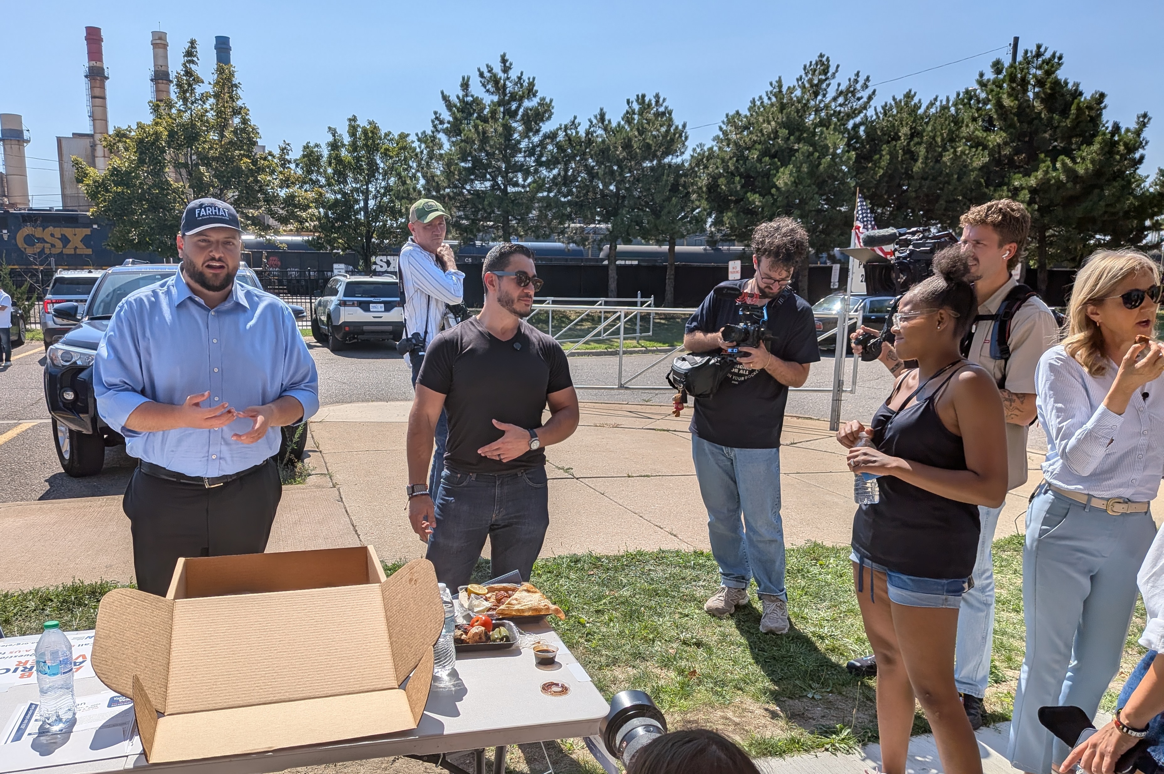 Michigan State Representative Alabas Farhat (left) and Senate candidate Abdul El-Sayed interact with voters in Dearborn, Michigan, on August 3
