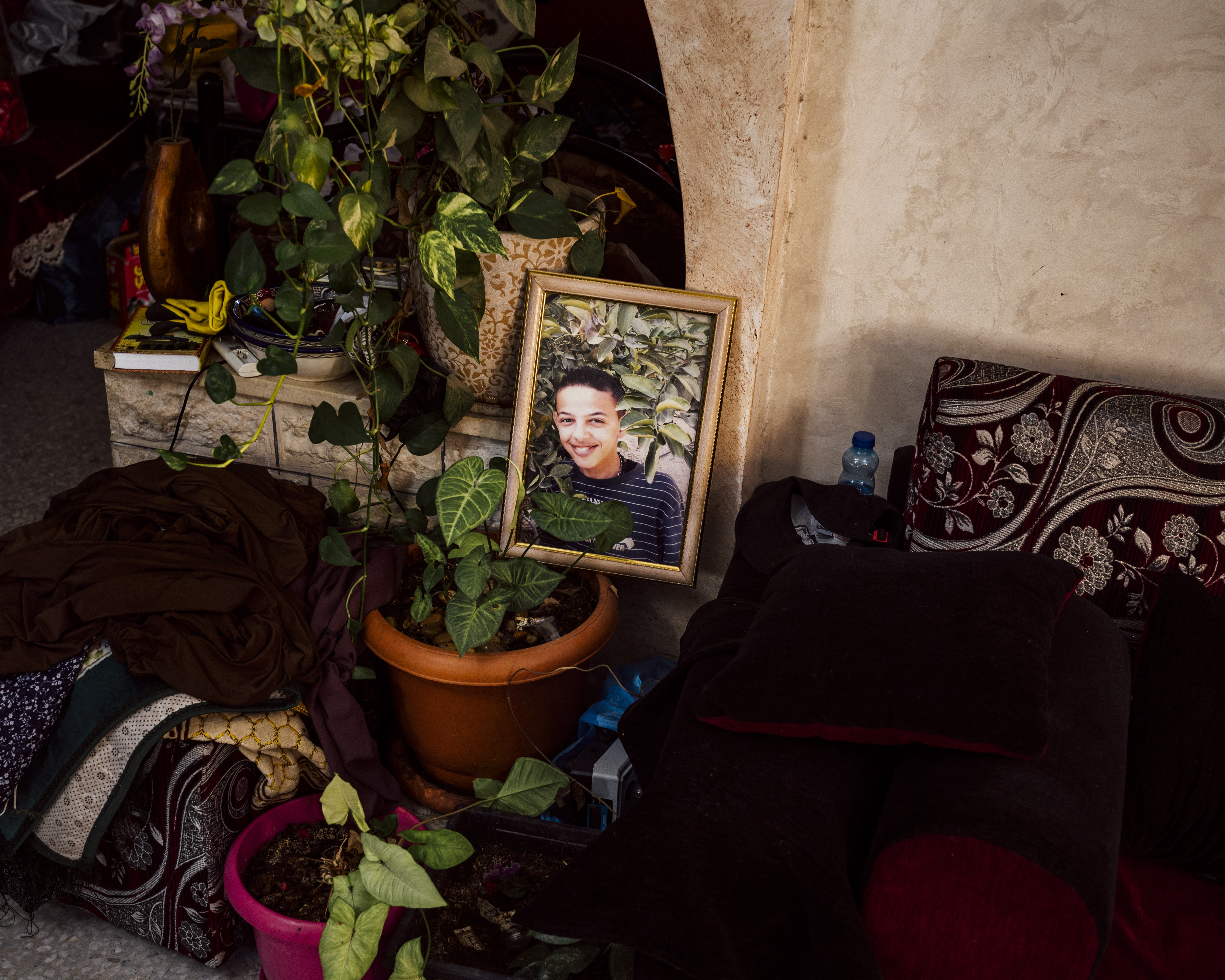 A picture of Mohammed Abu Khdeir in the living room of his home, in Shuafat neighbourhood of Occupied East Jerusalem. Mohammed was kidnapped outside his home and murdered by Israeli Jewish citizens on July 2nd 2014 [Lucien Lung/Al Jazeera]