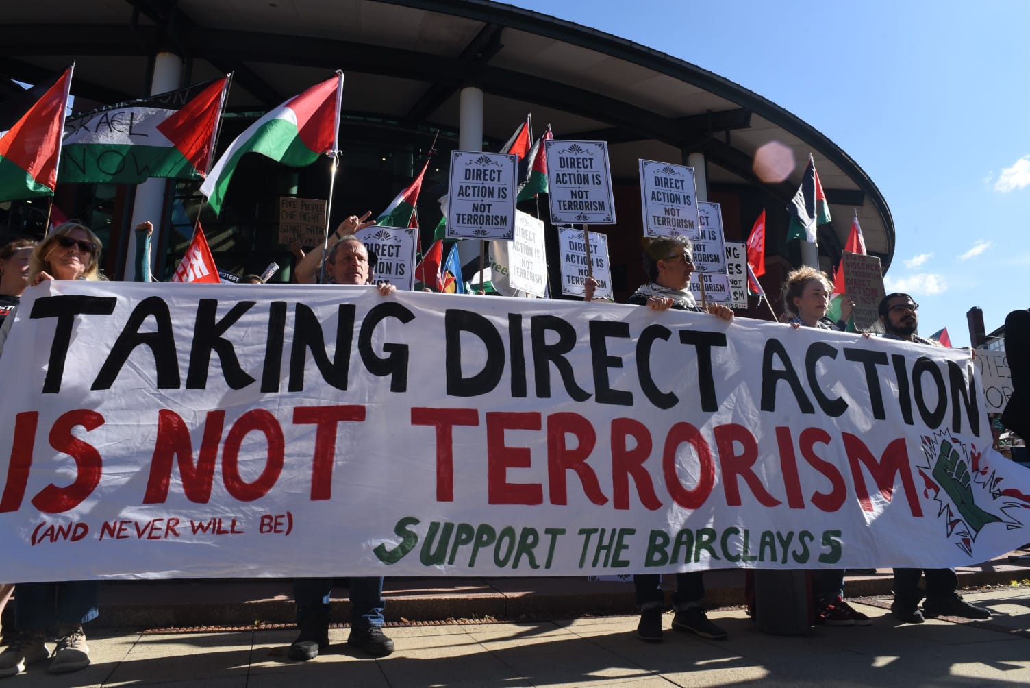 People protest outside the Preston court in support of the five activists